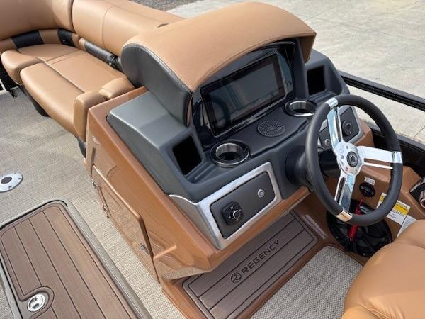 2025 Regency 230 LE3 boat interior with steering wheel and dashboard.