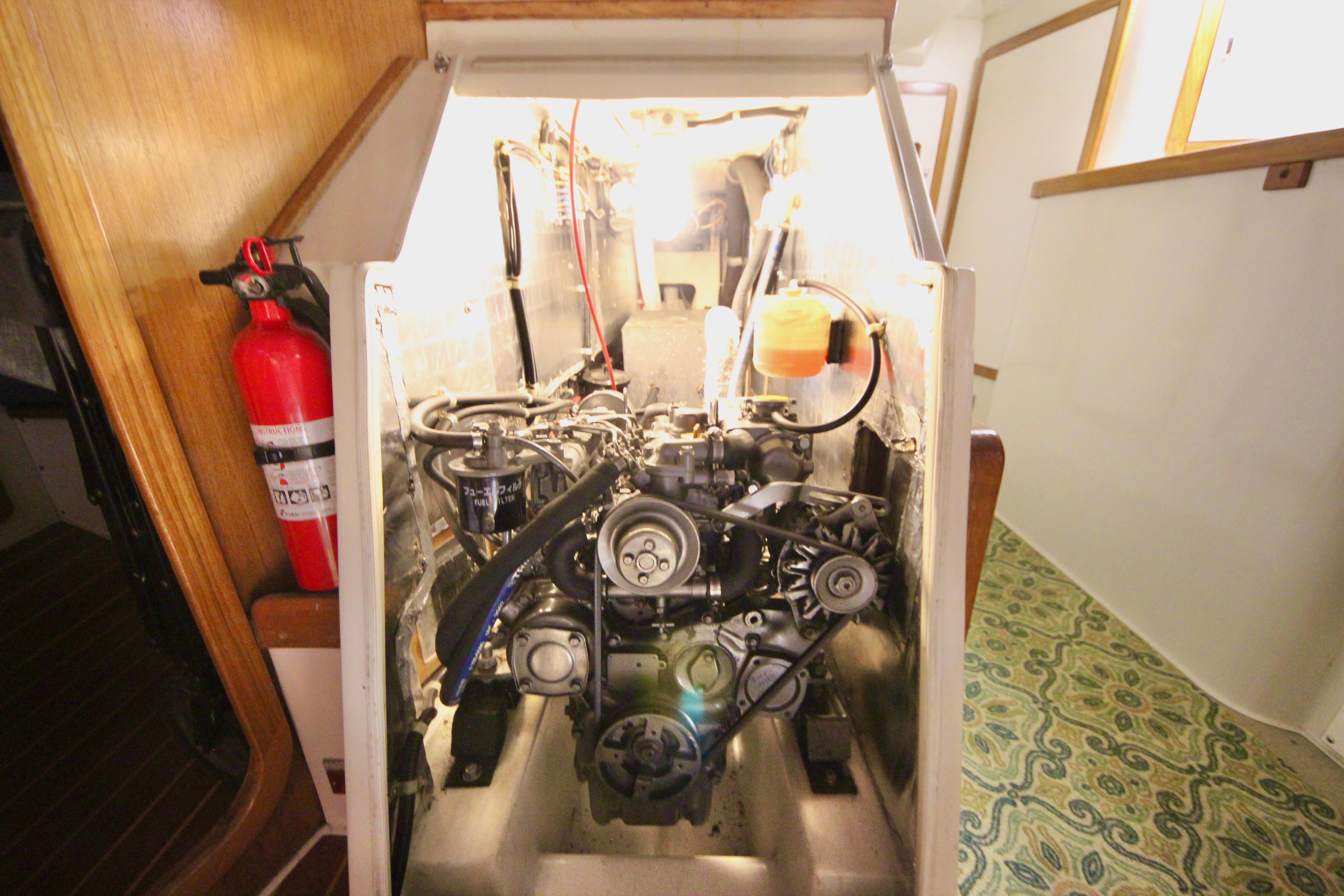 Engine compartment of a 1993 Catalina 42 MKI sailboat, featuring a visible fire extinguisher.