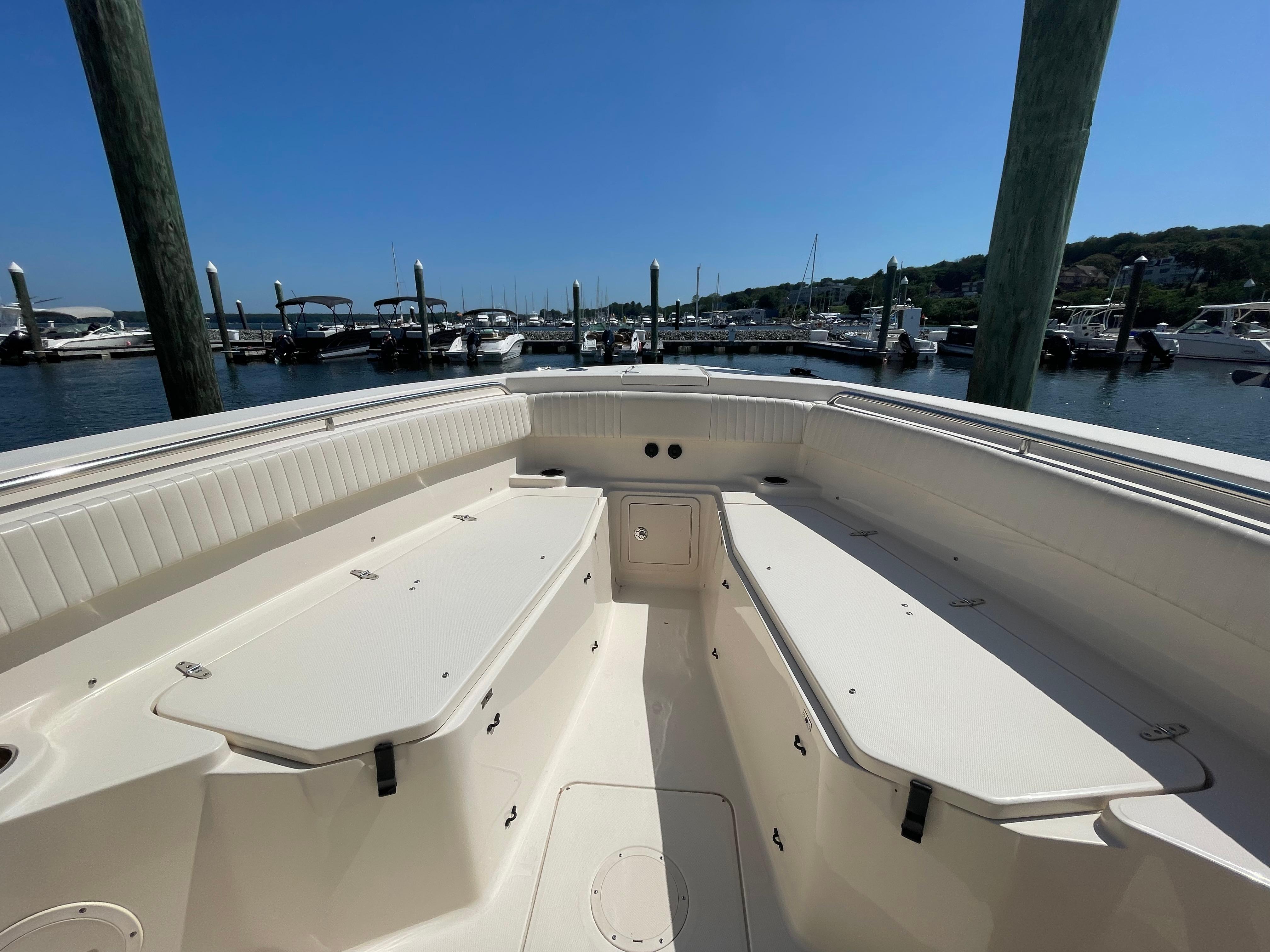 2014 Grady-White Canyon 306 boat interior at marina, clear sky, calm water.
