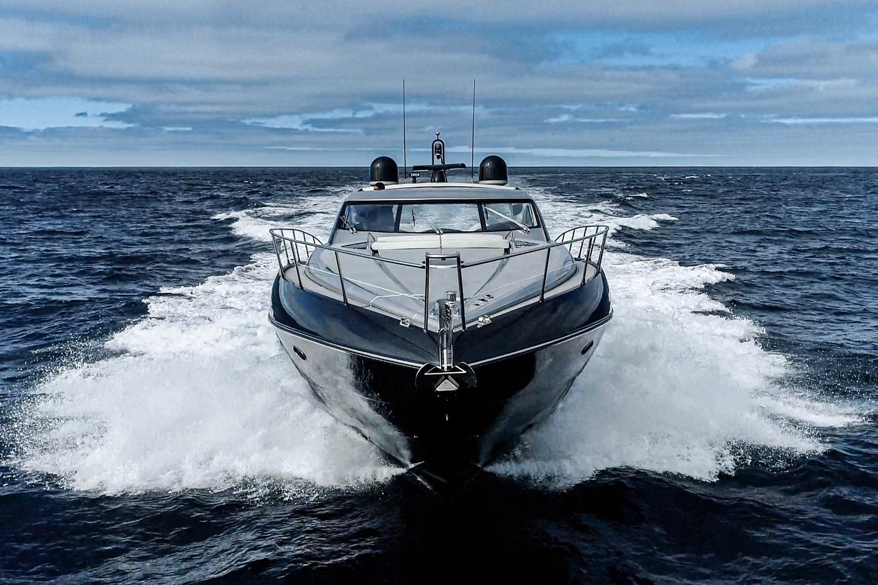 2021 Sunseeker Predator 68 yacht cruising on open sea under cloudy sky.
