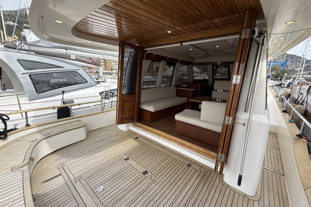 Spacious deck and interior of 2012 Sasga Yachts Menorquin 42, featuring elegant wood finishes.