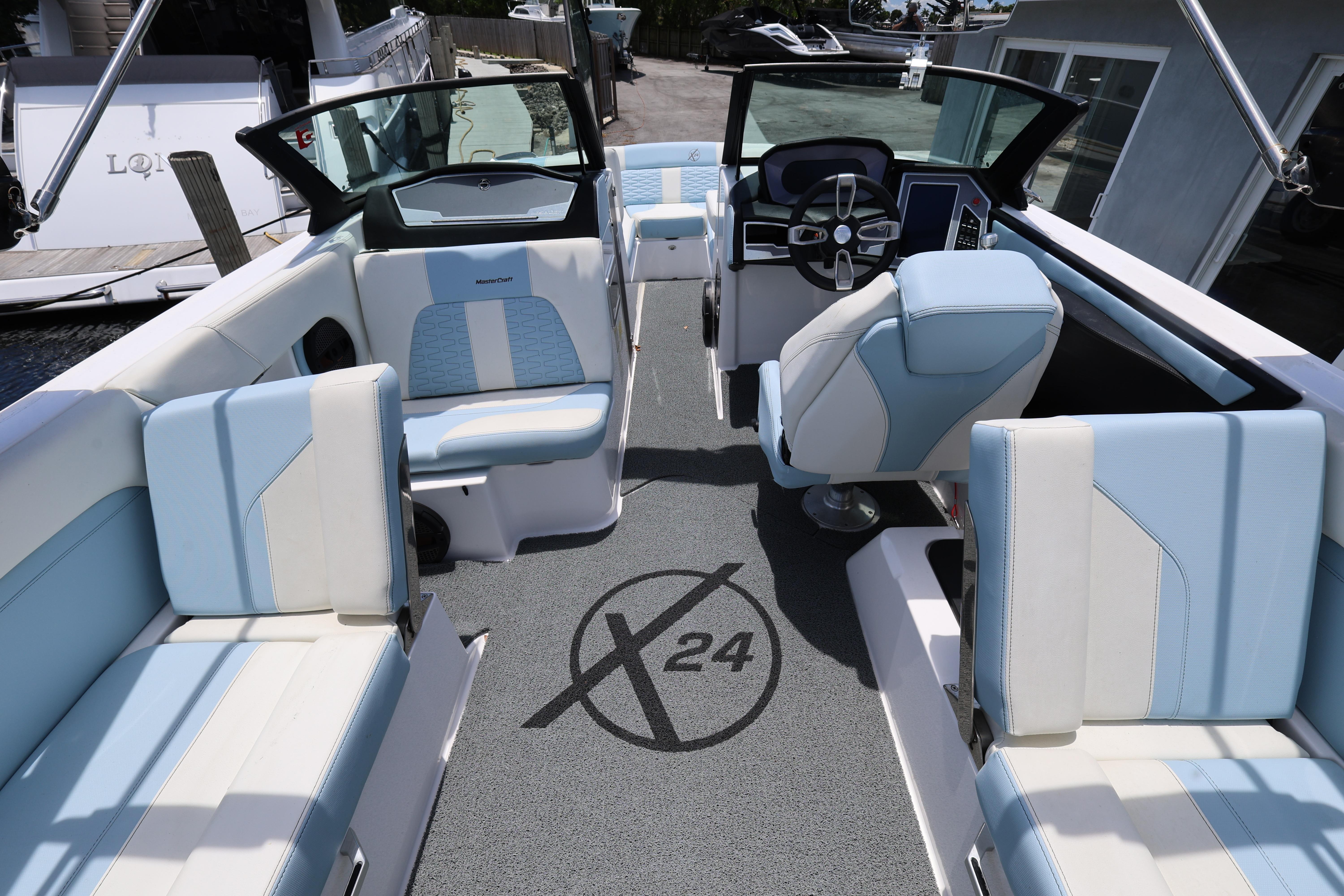 2023 MasterCraft X24 boat interior with modern seating and steering, showcasing luxury design.