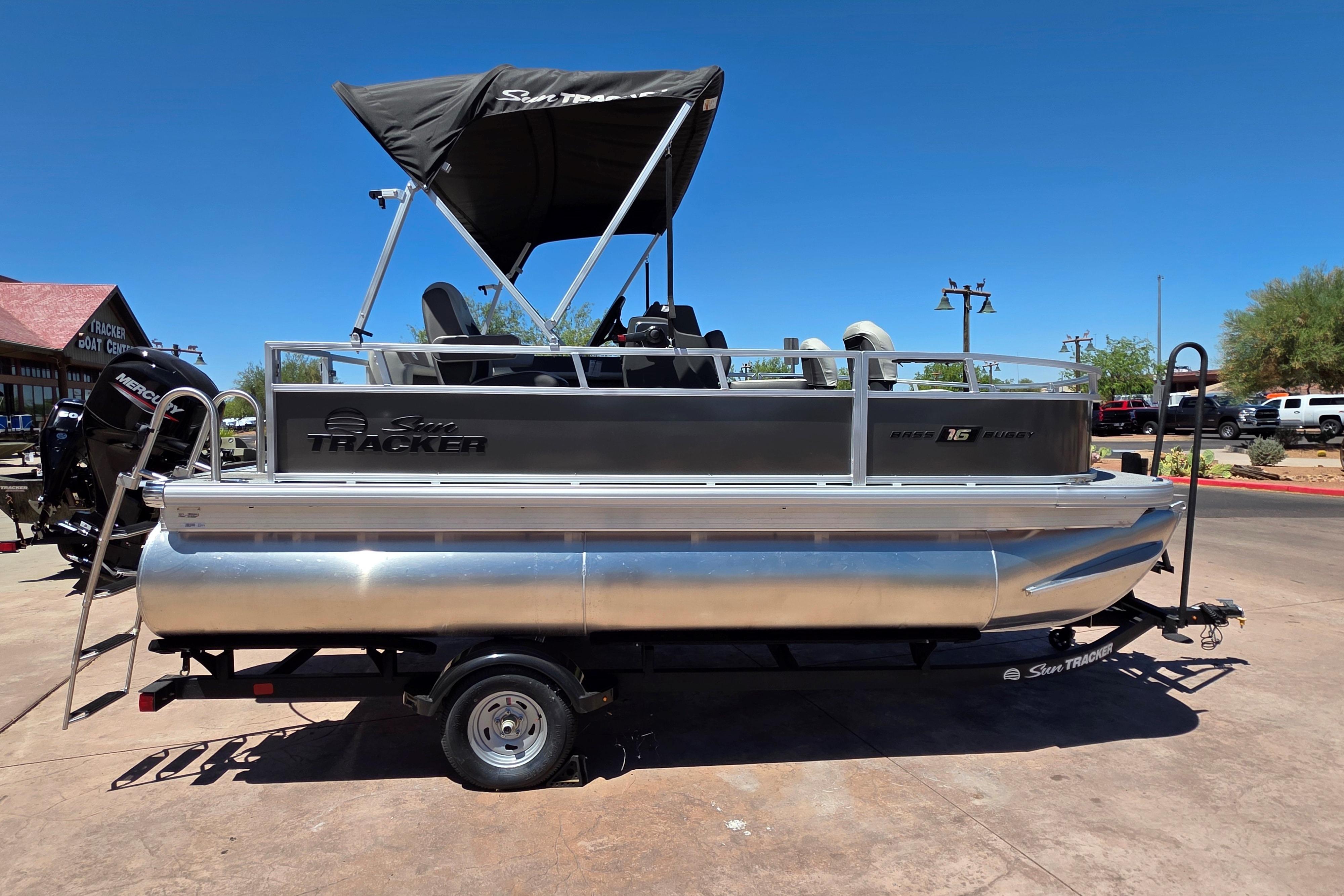 2026 Sun Tracker Bass Buggy 16 XL Select pontoon boat on trailer, outdoor display.