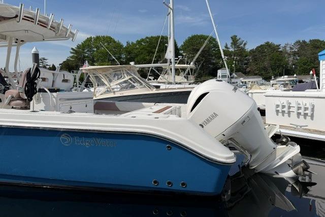 2014 Edgewater 318CC boat with Yamaha engine docked at marina.
