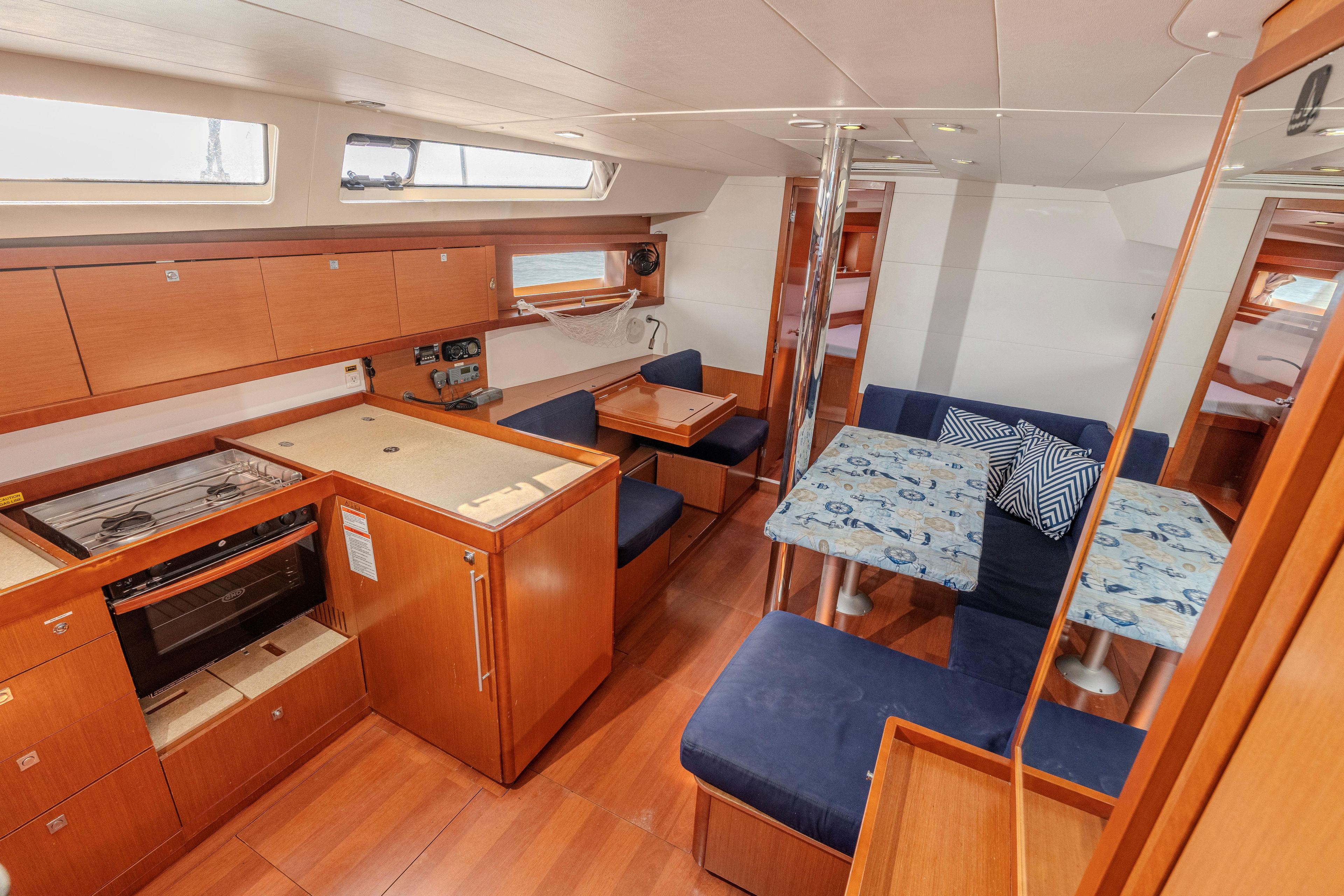 Interior of 2013 Beneteau Oceanis 41 yacht with modern kitchen and cozy seating area.