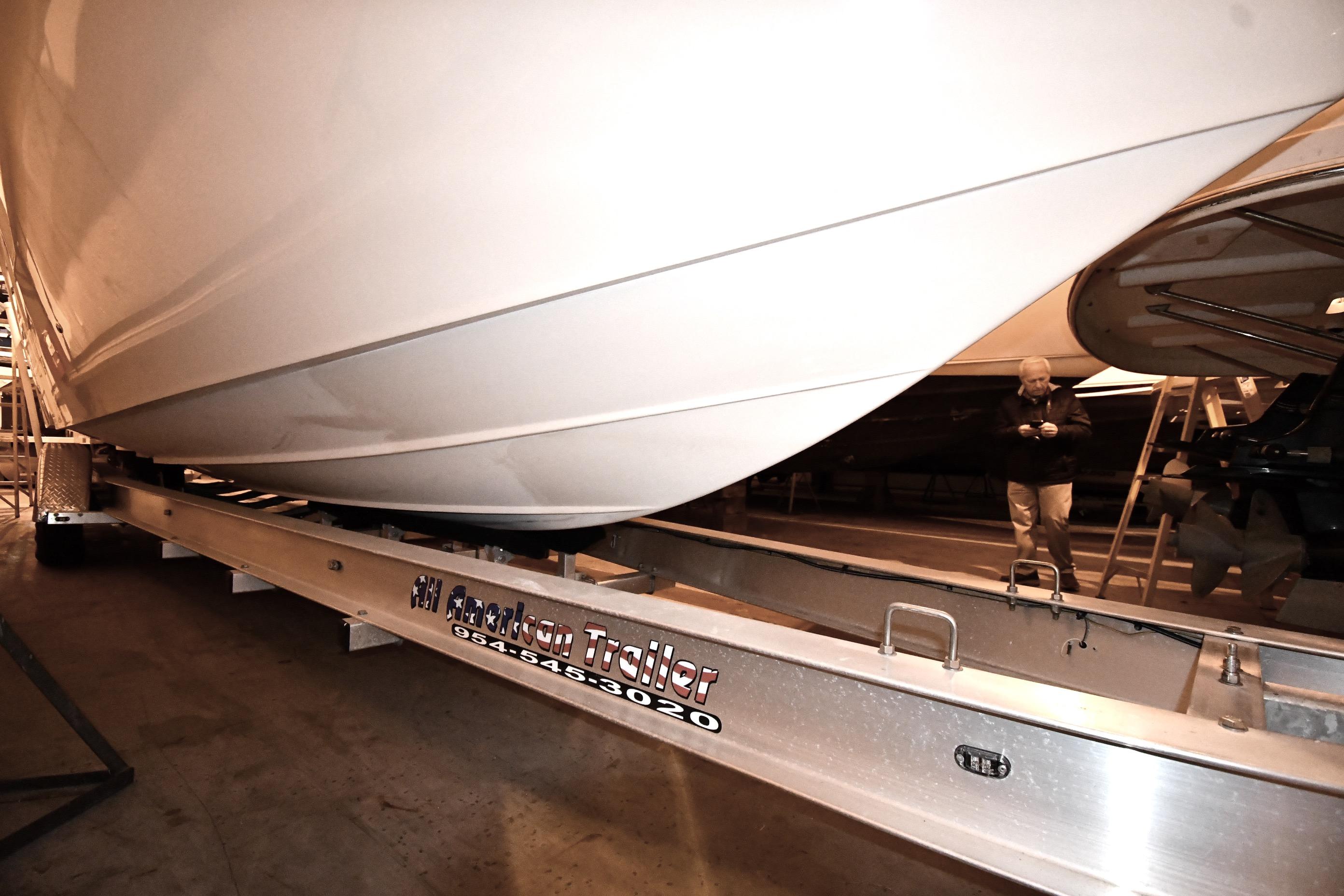 2001 Fountain 38 Center Console boat on trailer in indoor storage facility.