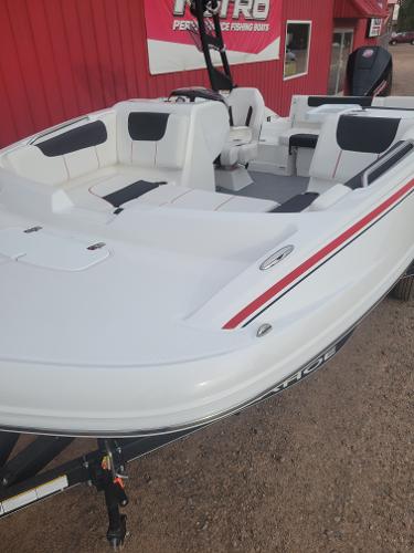 2024 Tahoe 1950 boat with white and black seating, displayed outdoors.