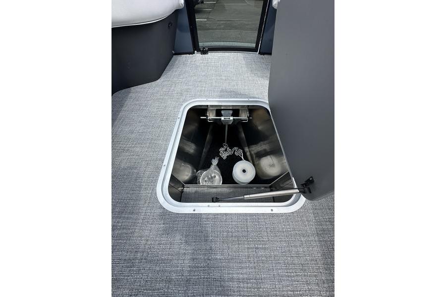 Storage compartment in 2026 Flamingo Rove 24' boat, featuring interior view and equipment.