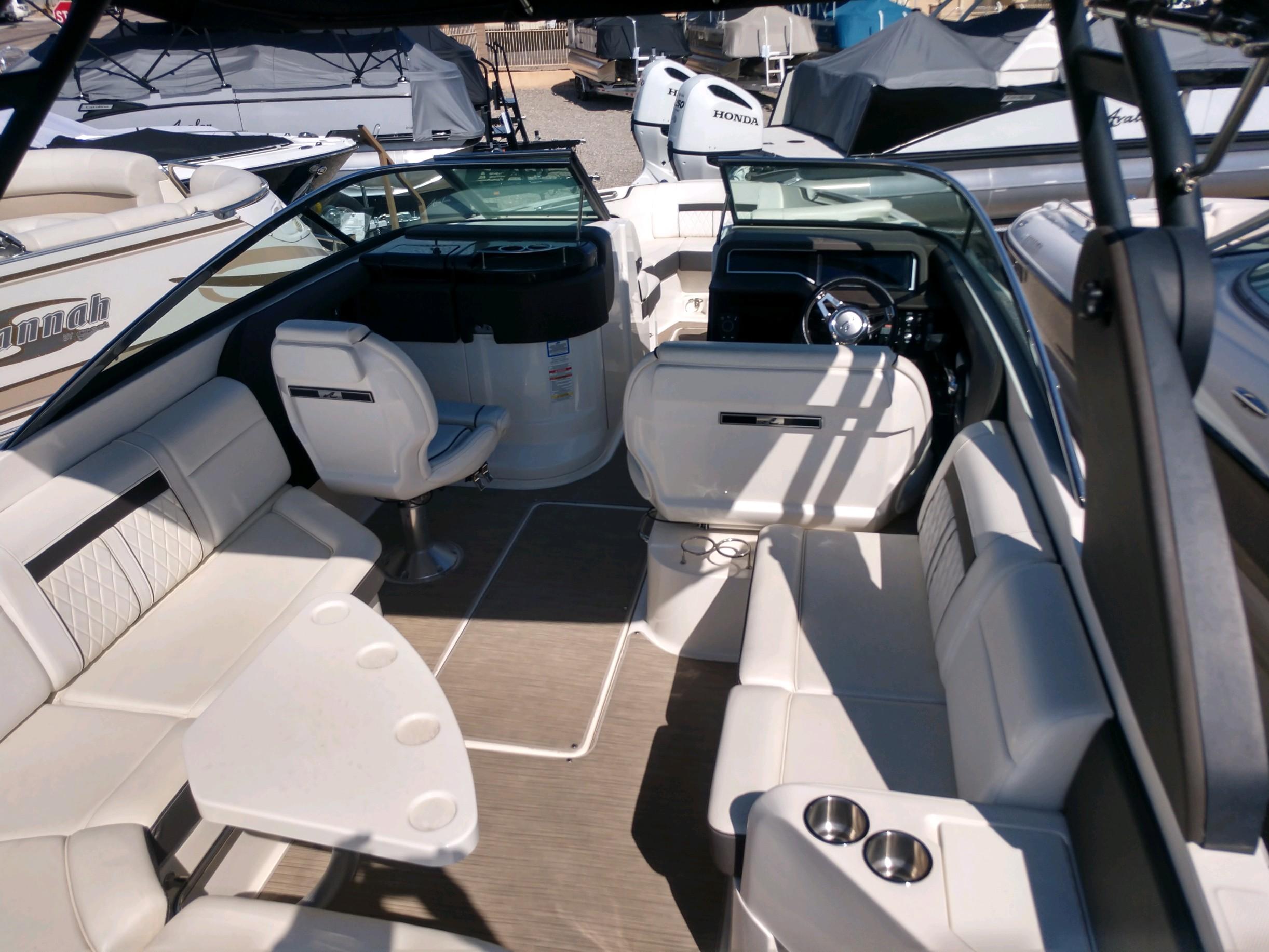 2018 Sea Ray SLX 280 boat interior with white seating and steering console.