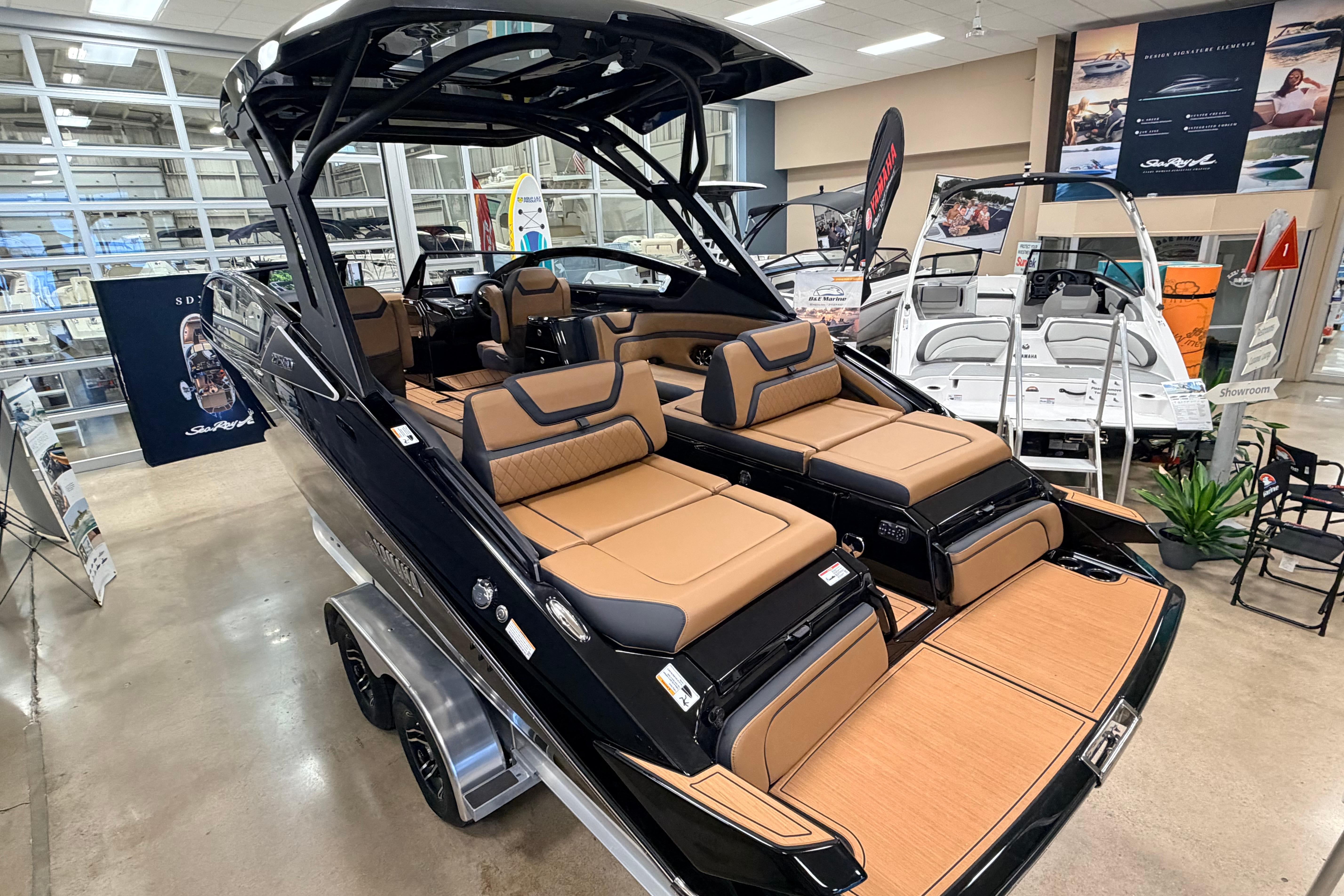 2026 Yamaha Boats 275SD in showroom, featuring luxurious tan seating and sleek design.