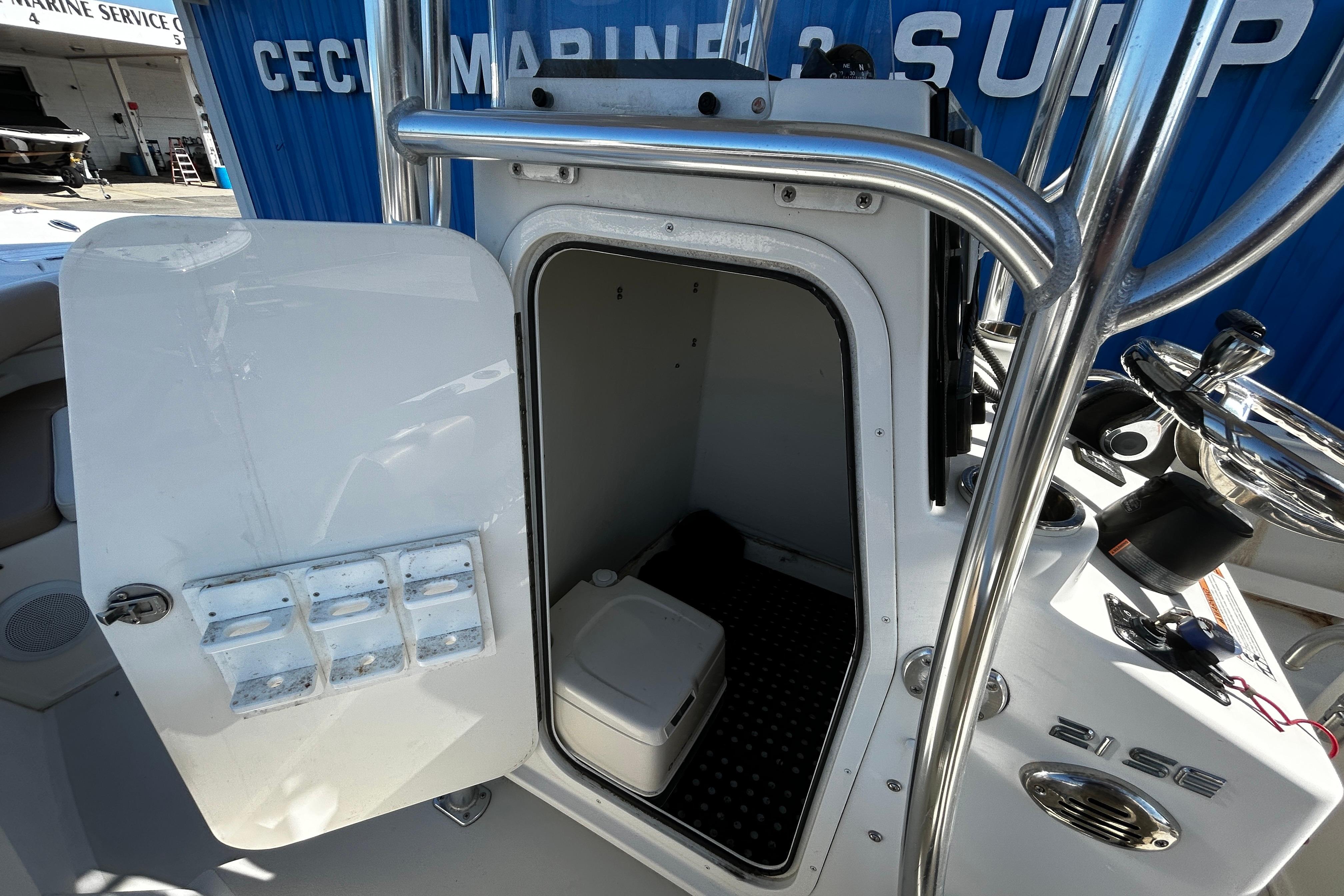Open storage compartment on a 2019 Parker 21 Special Edition boat, showcasing interior space.