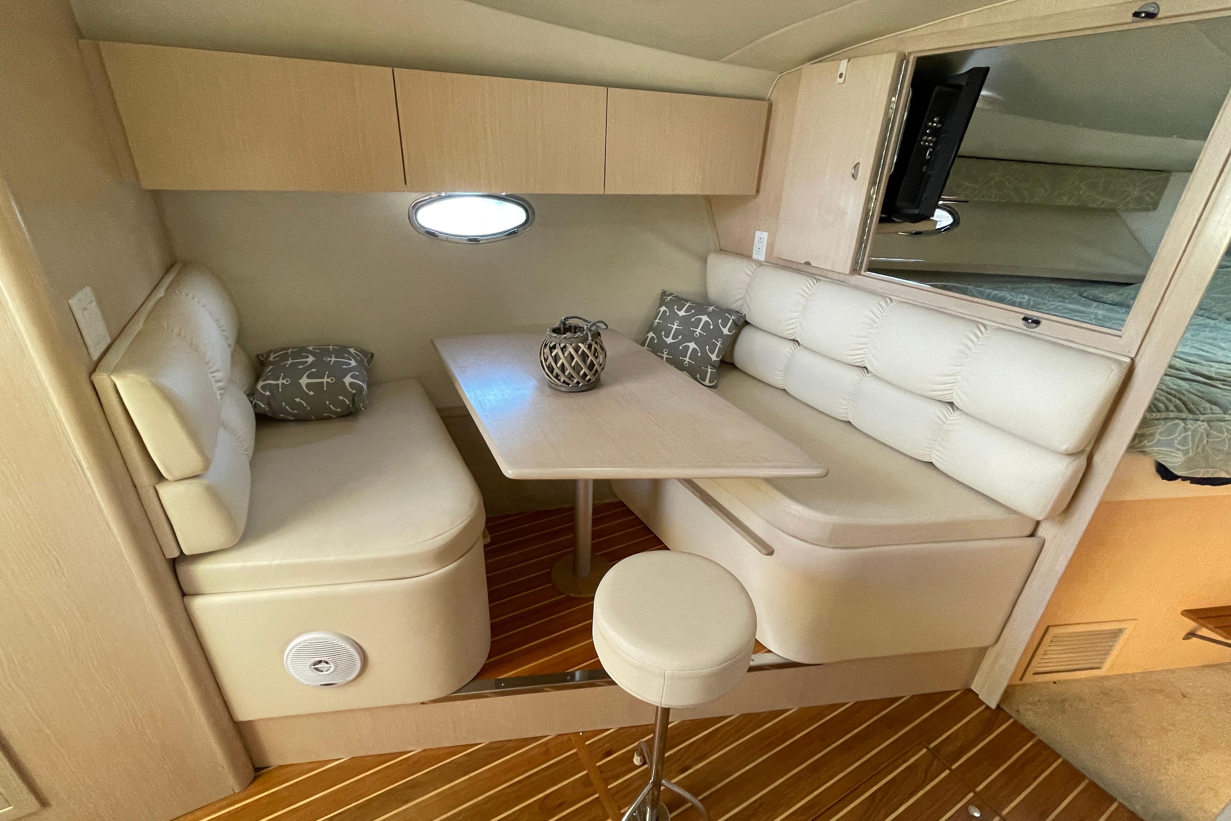 Interior of 1995 Tiara 3500 EXPRESS yacht with cozy dining area and plush seating.