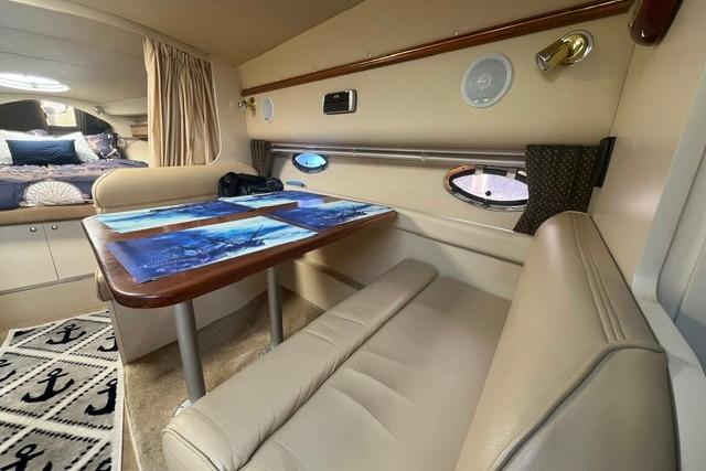 Interior of 2004 Cruisers Yachts 3372 Express with dining area and nautical decor.