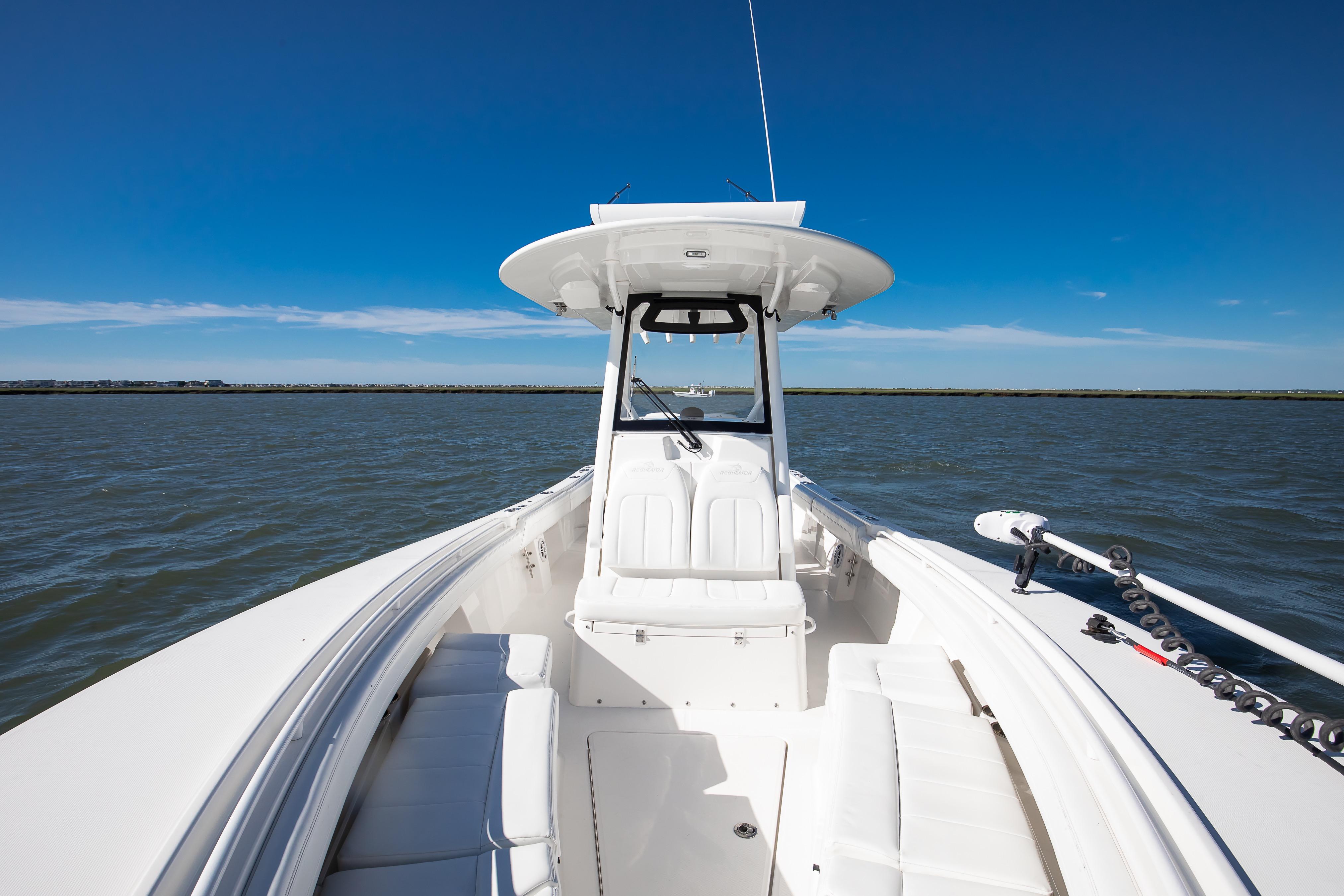 2022 Regulator 28 Forward Seating boat on open water under clear blue sky.