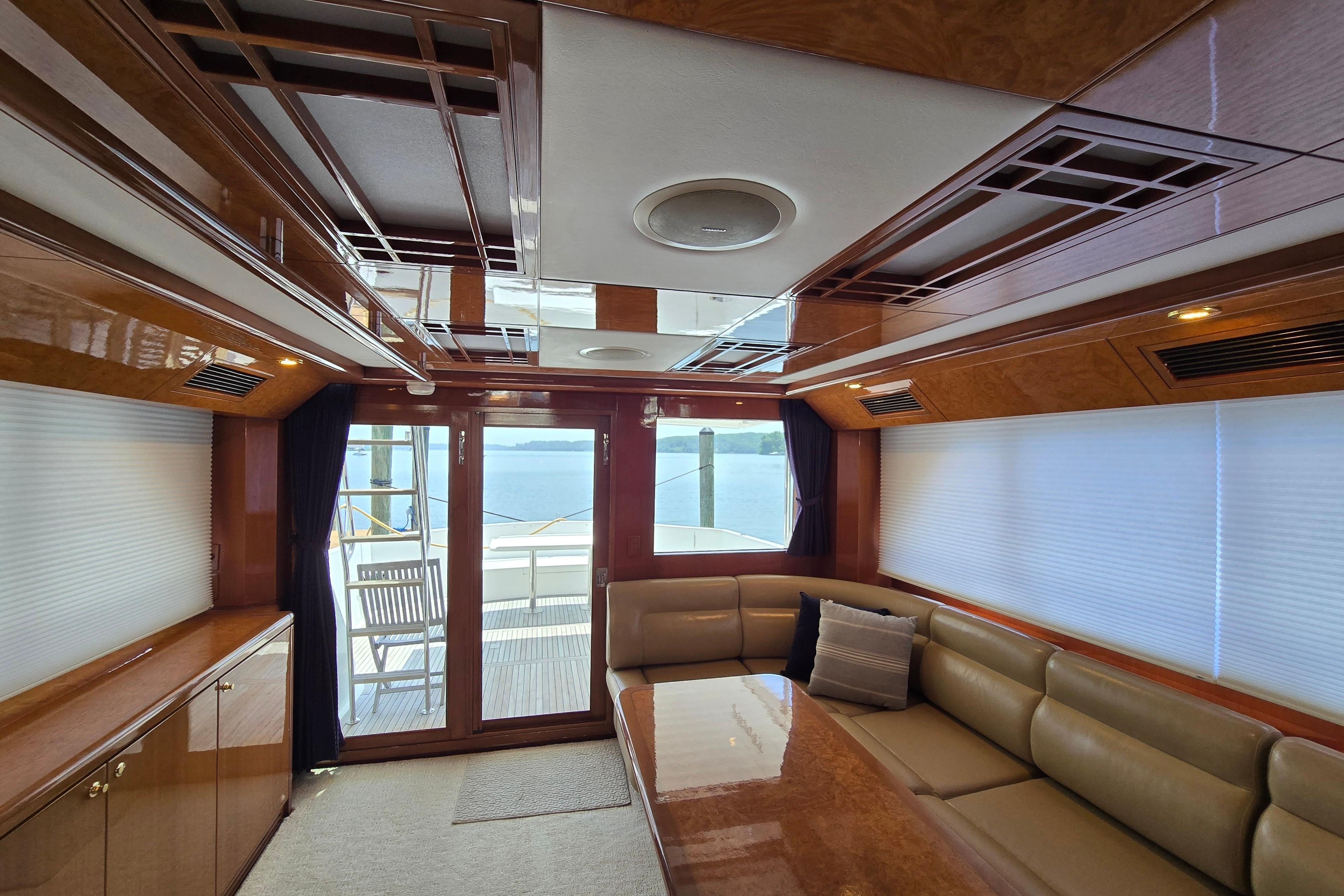 Luxurious interior of 2004 Grand Harbour 58 yacht with elegant wood finishes and comfortable seating.