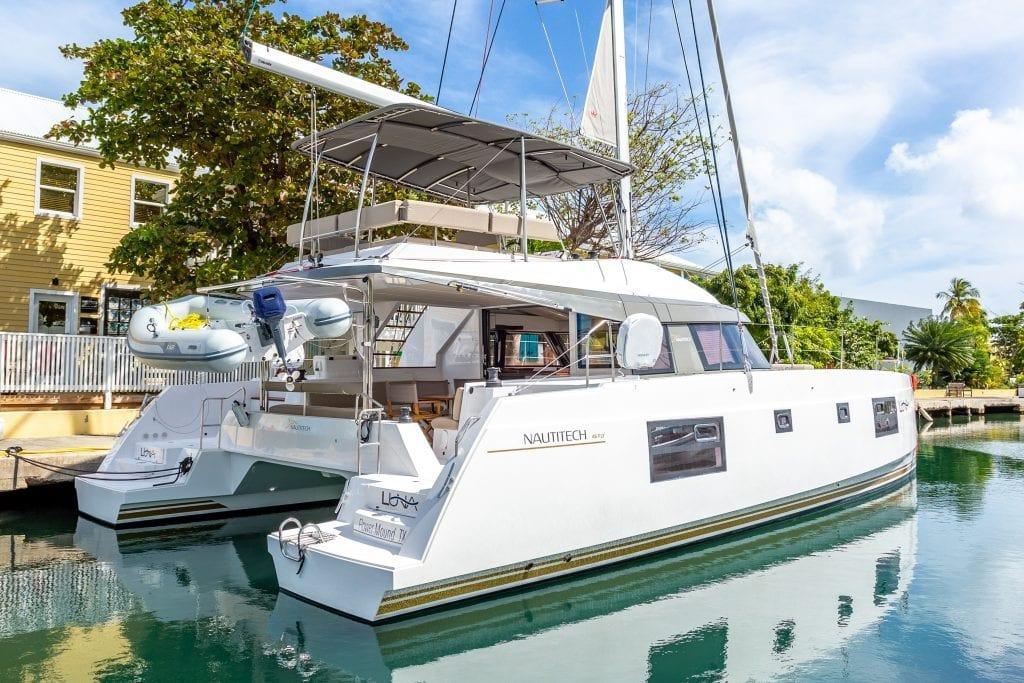 2020 Nautitech 46 Fly catamaran docked, featuring sleek design and spacious deck.