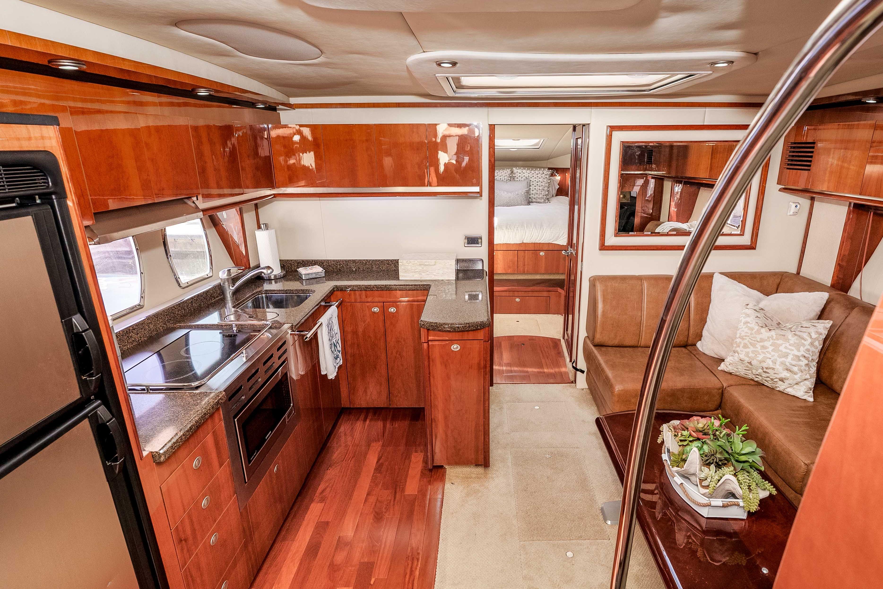Luxurious 2007 Sea Ray 48 Sundancer yacht interior with modern kitchen and cozy seating area.