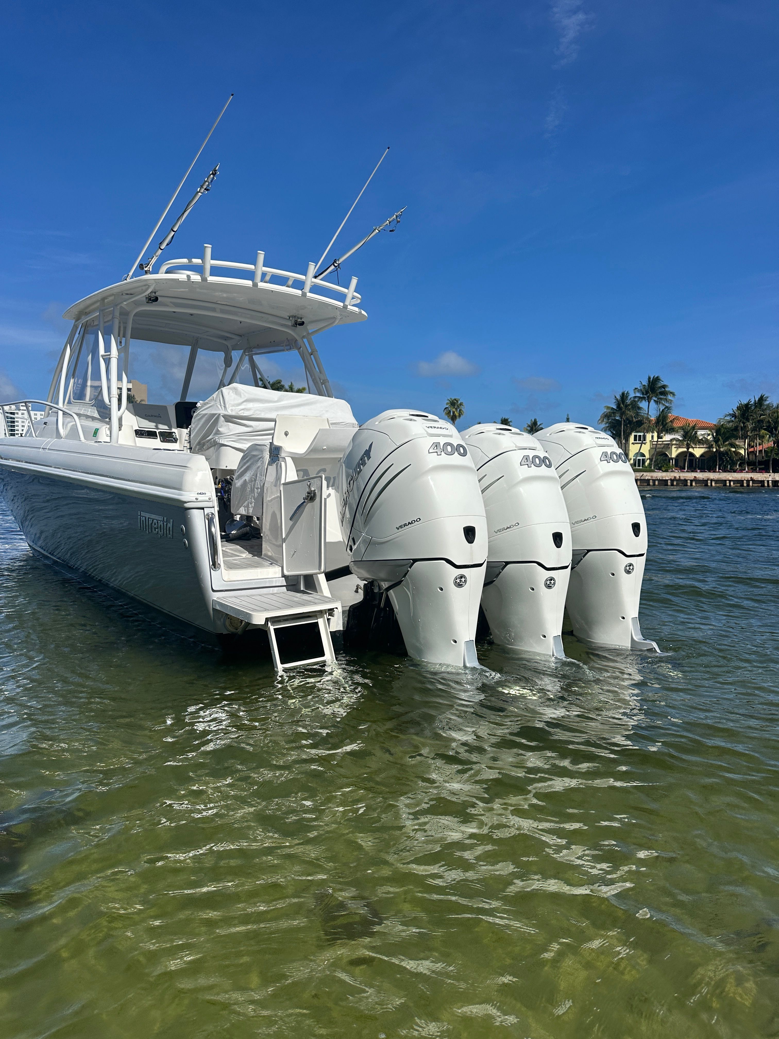 2004 Intrepid 377 Walkaround with triple outboard engines in water.