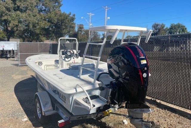 2026 Mako 18 Pro Skiff boat on trailer, featuring powerful outboard motor.