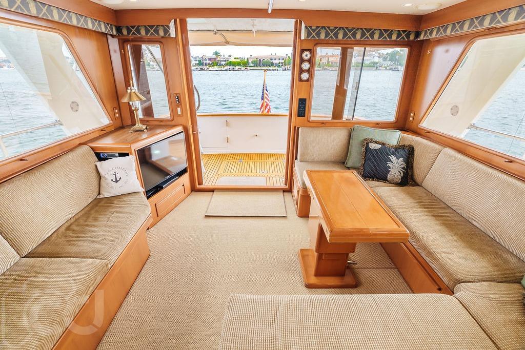 Luxurious interior of 1999 Offshore Yachts 52 Pilothouse with elegant seating and wooden accents.