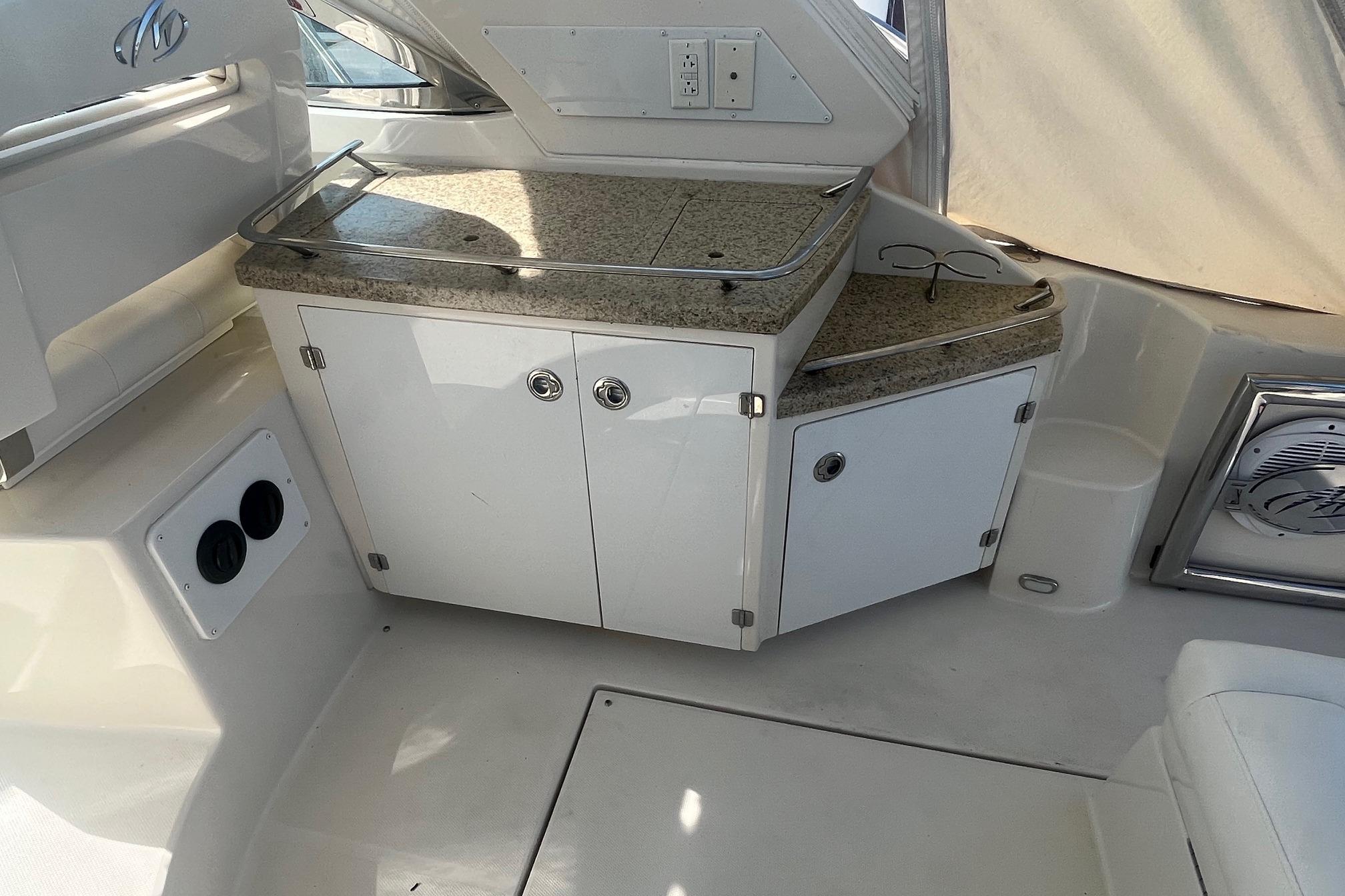 Interior of 2010 Monterey 400 Sport Yacht with granite countertop and storage cabinets.