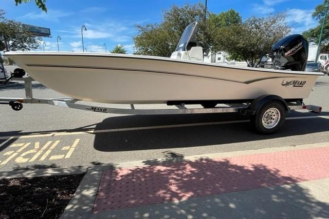 2026 Mako Pro Skiff 17 CC boat on trailer in parking lot.