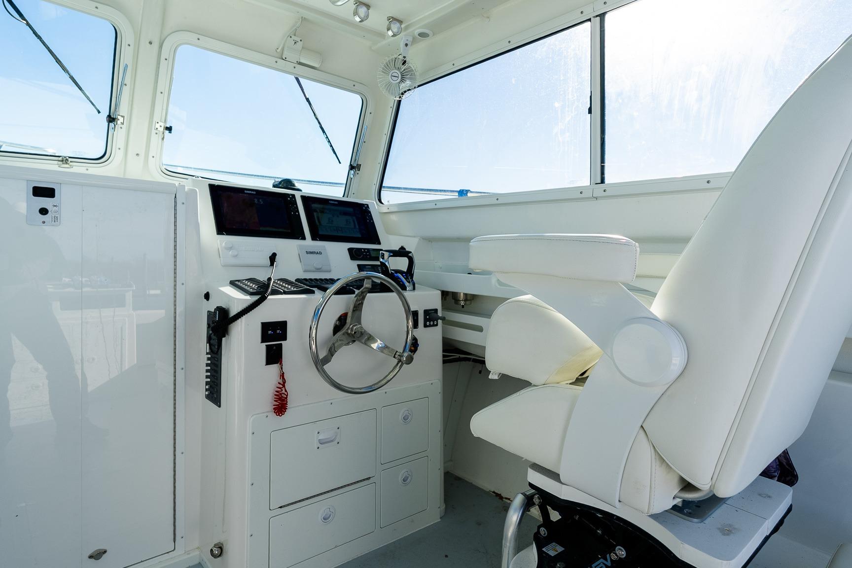 2024 Steiger Craft 31 Fisherman helm with modern controls and comfortable captain's chair.
