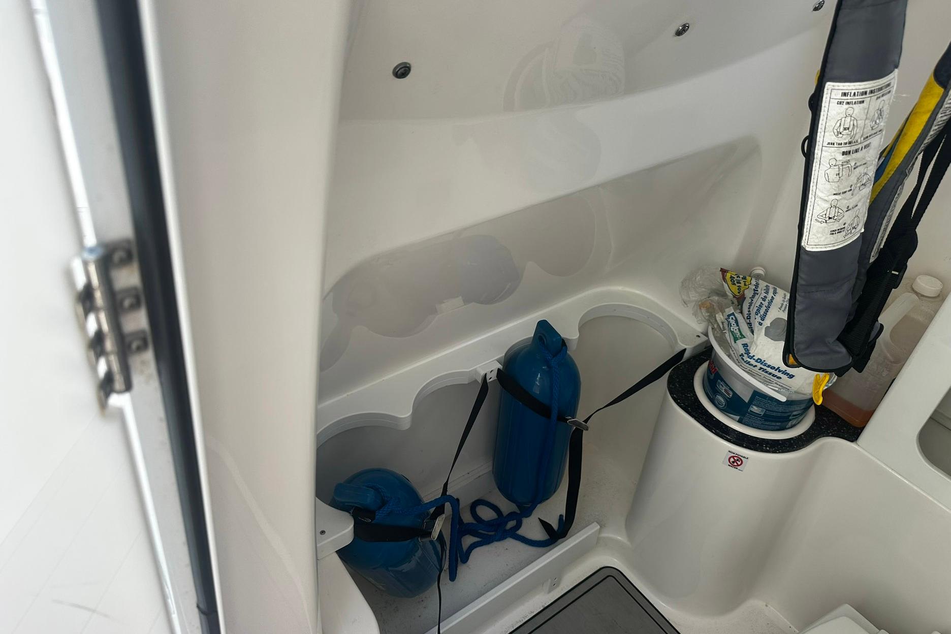 Interior storage of 2002 Sea Fox 228 Commander boat with safety equipment.