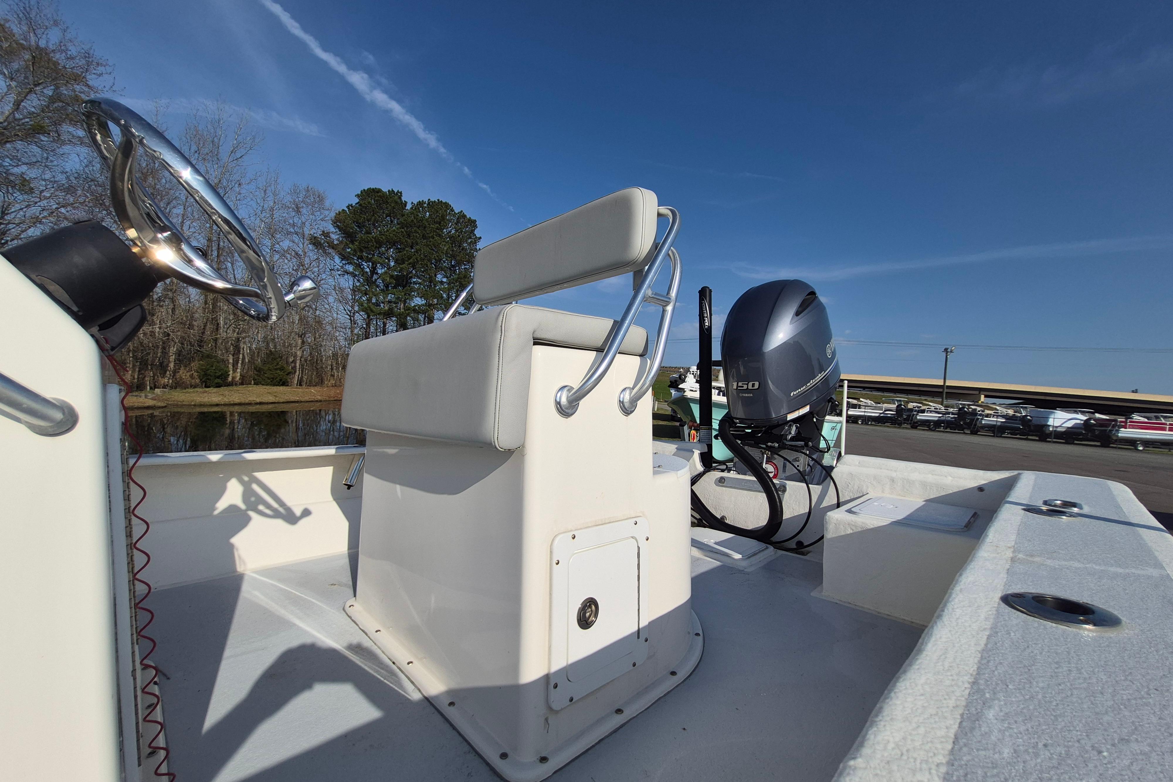 2024 May-Craft 22 Hancock Skiff boat with steering console and outboard motor.