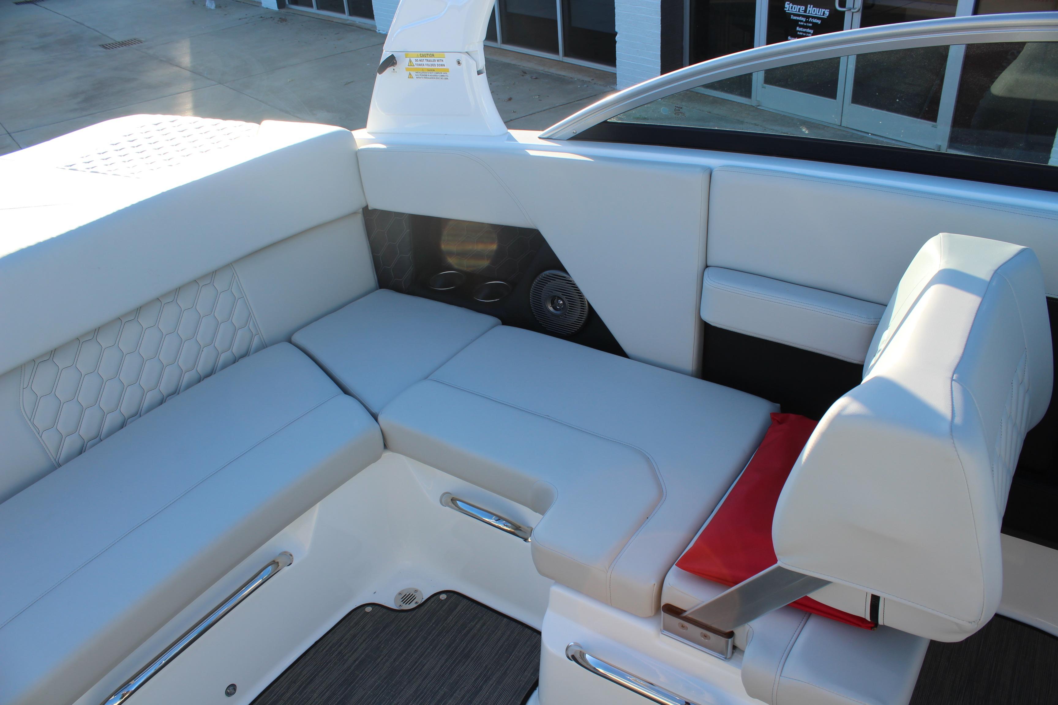 2026 Four Winns H2 Freedom boat interior with white cushioned seating and modern design.