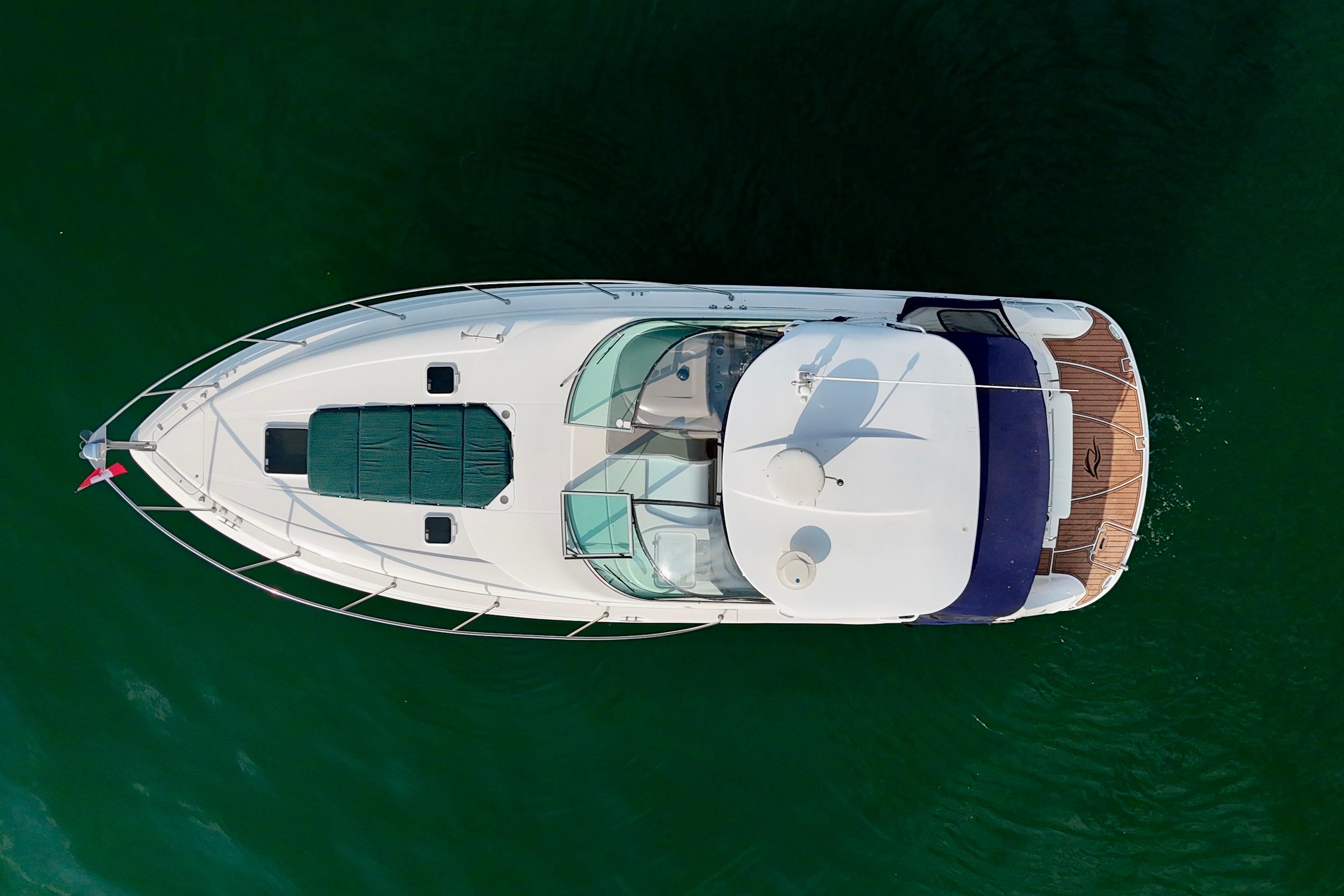 Aerial view of 2009 Rinker 360 Express Cruiser on green water.