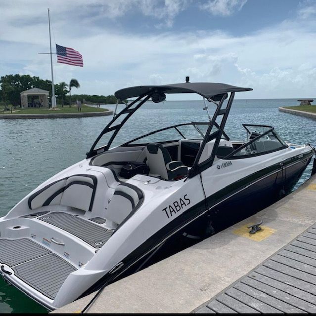 2016 Yamaha AR240 boat docked with American flag in background.