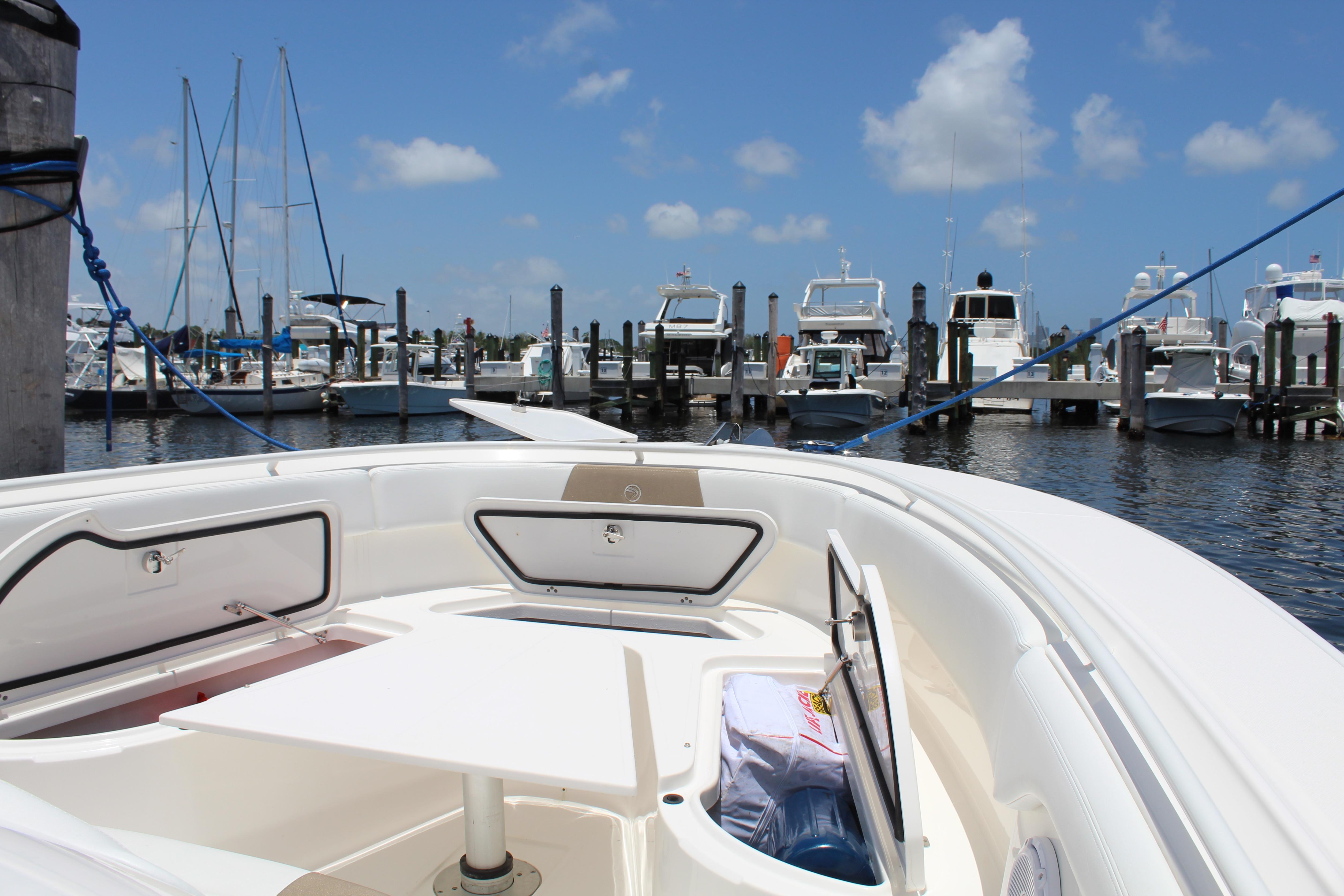2016 Edgewater 370CC boat docked at marina under clear blue sky.