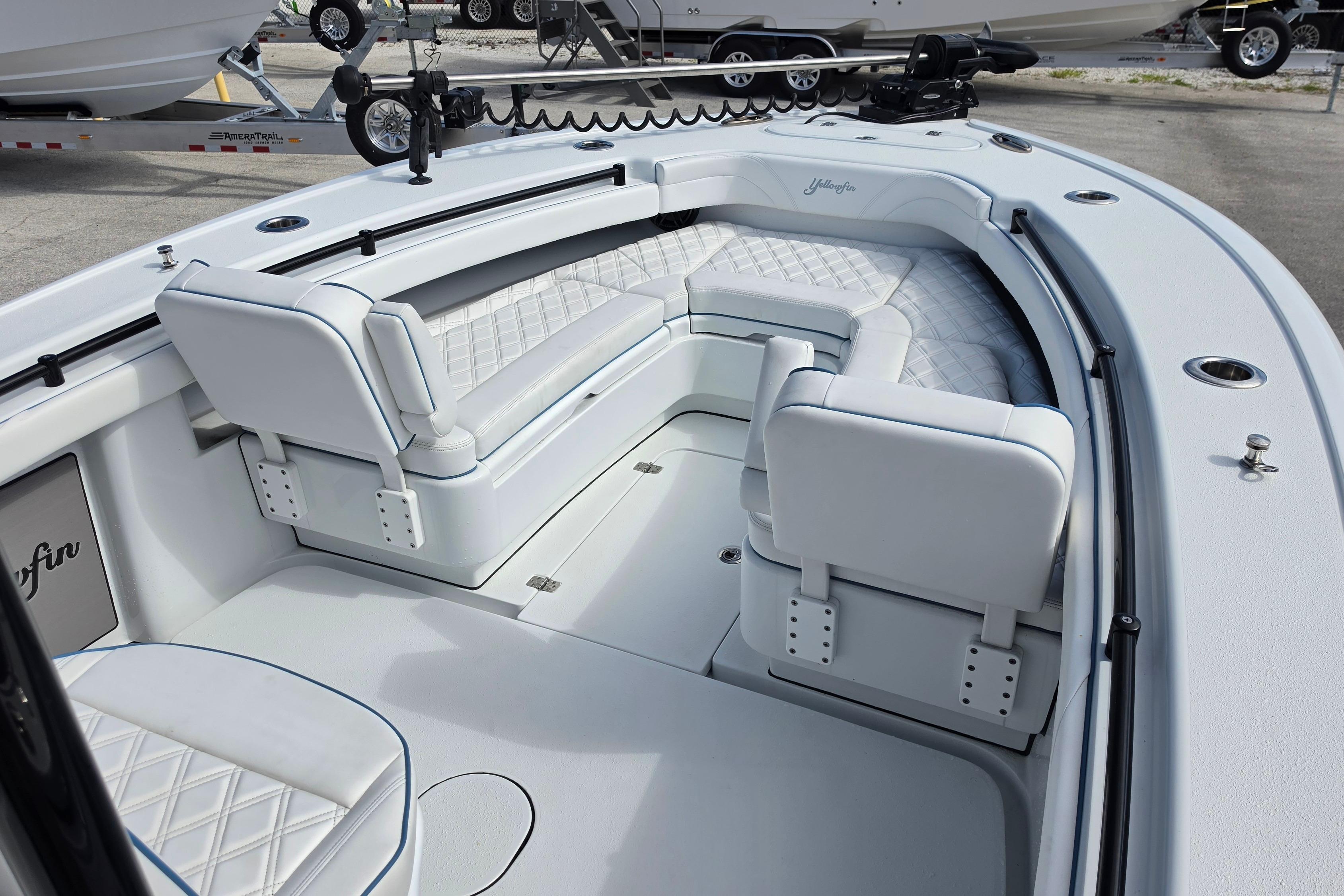 2025 Yellowfin 26 Hybrid boat interior with white cushioned seating and modern design.