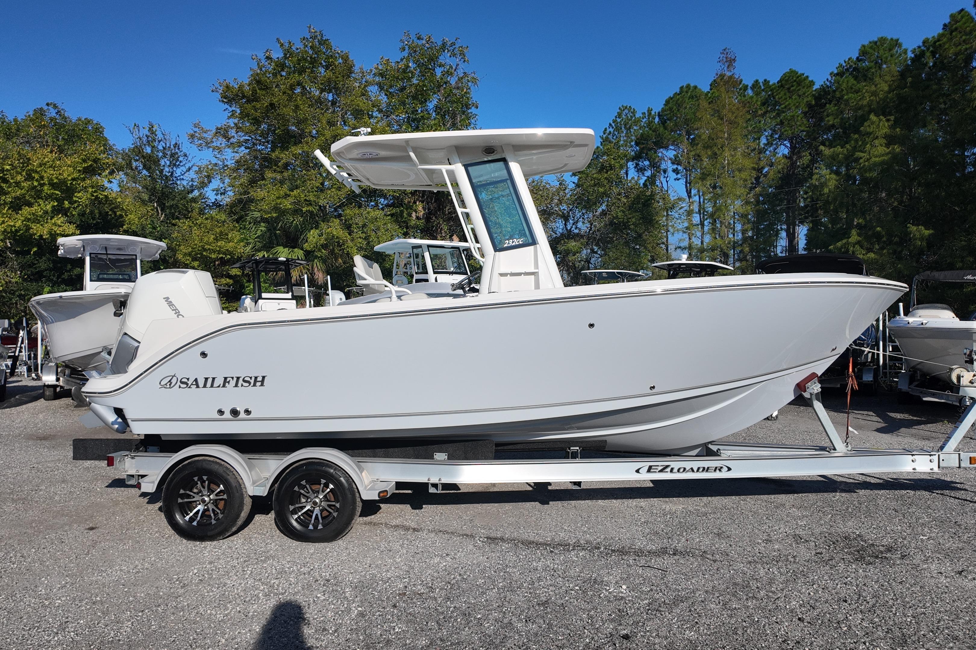 2026 Sailfish 232 CC boat on trailer, parked outdoors with trees in background.