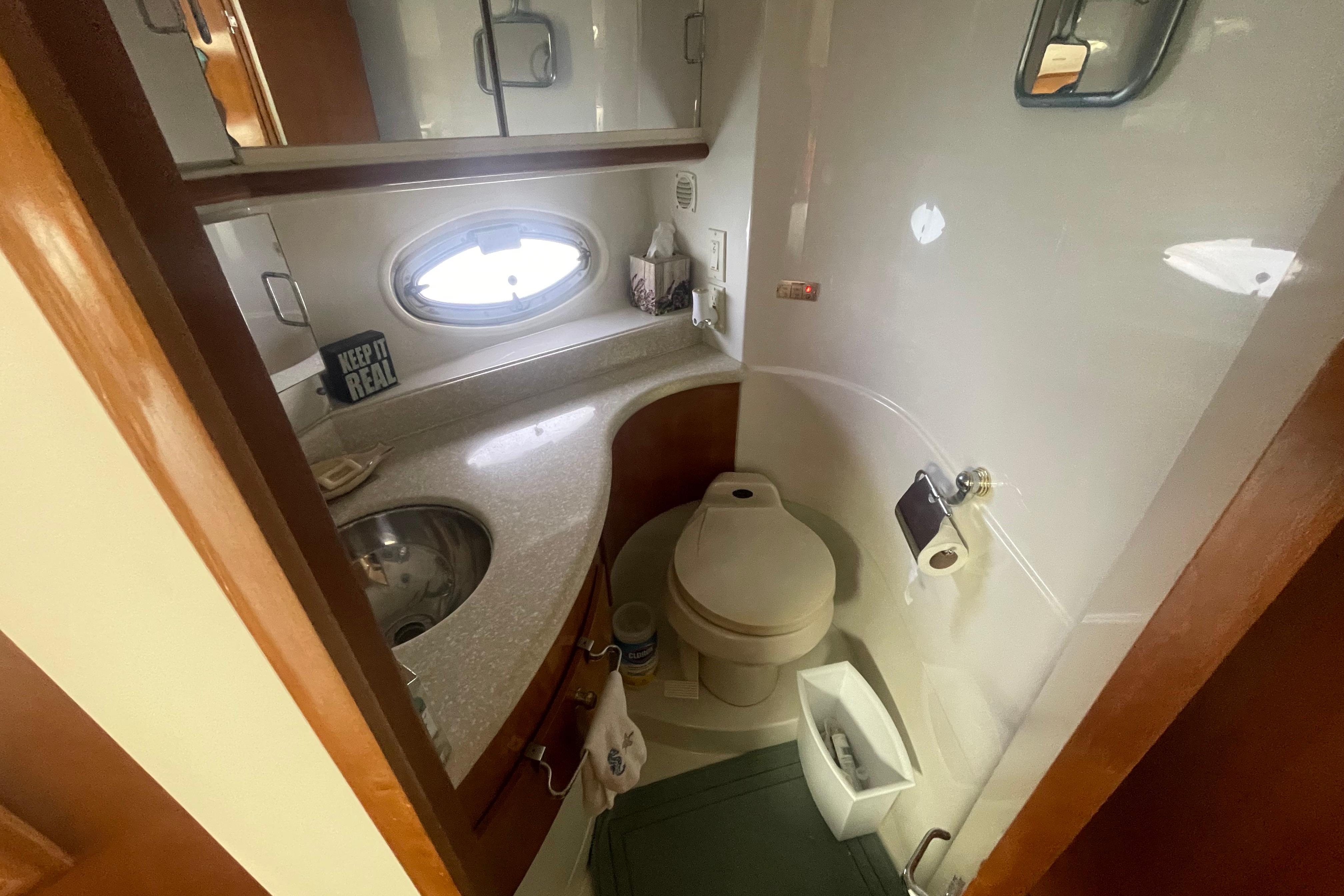 Bathroom interior of 2002 Carver 410 Sport Sedan yacht, featuring sink and toilet.