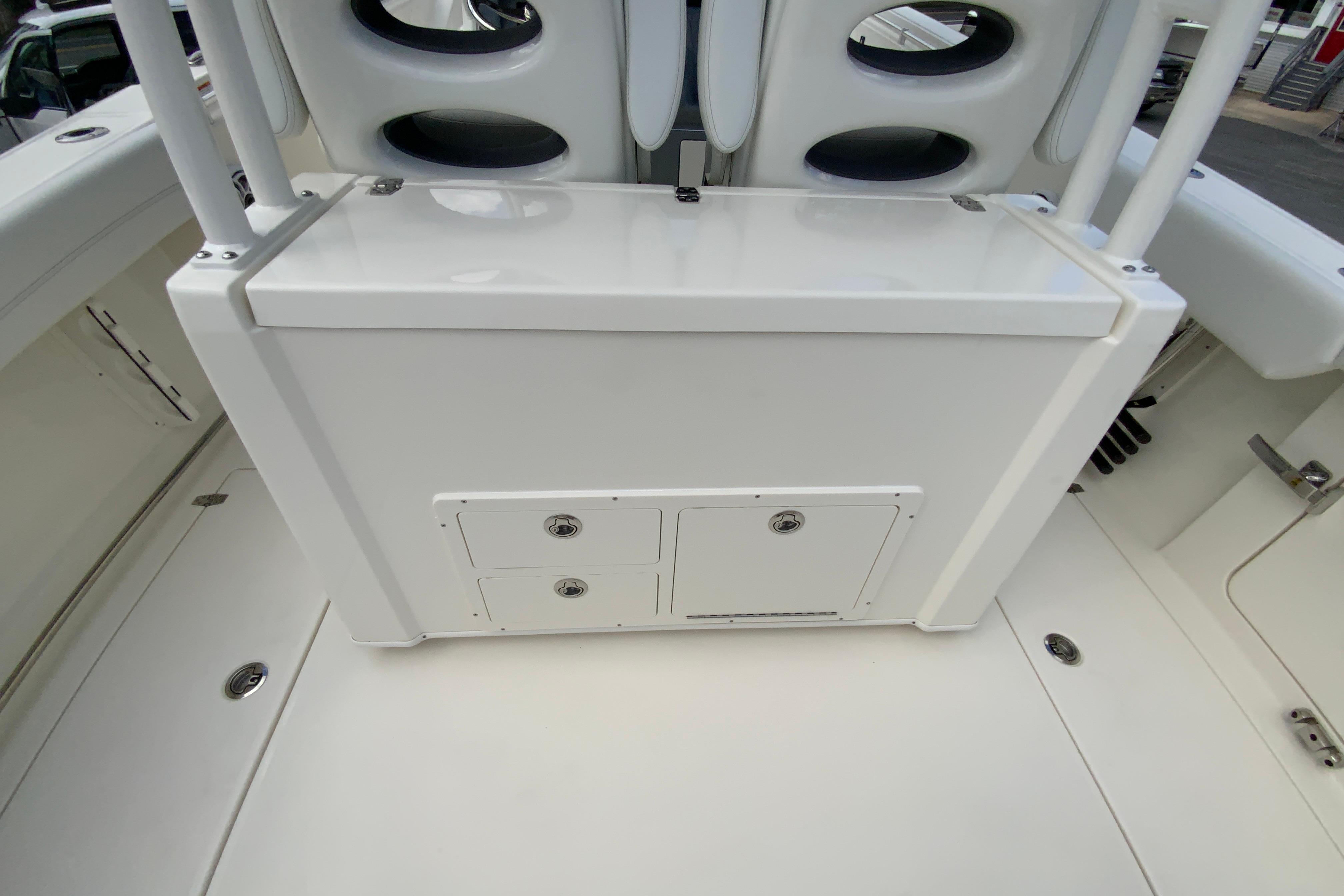 2027 Cobia 320 Center Console boat interior with storage compartments and seating.