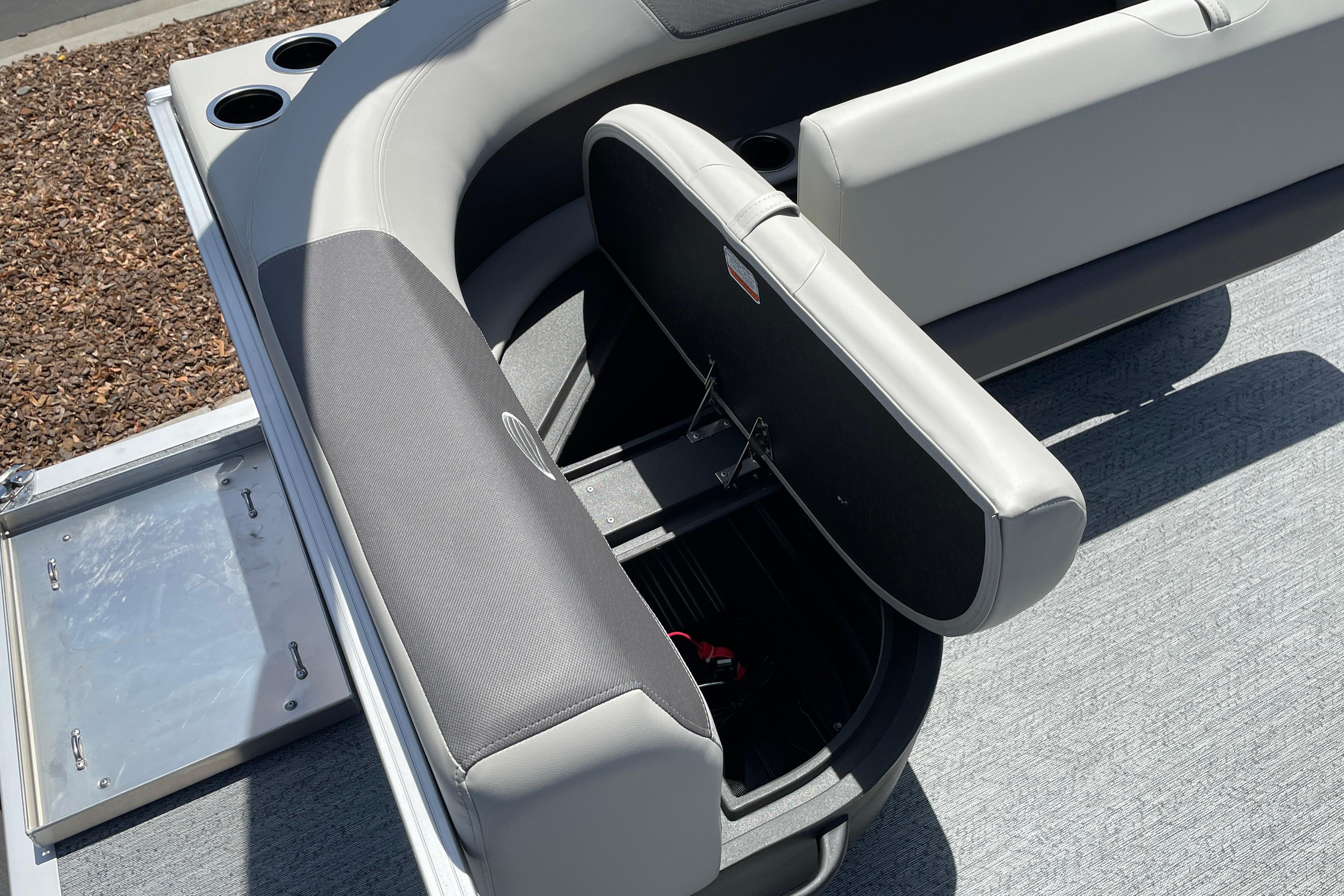 2026 Sun Tracker Bass Buggy 16 XL Select boat seat with open storage compartment.