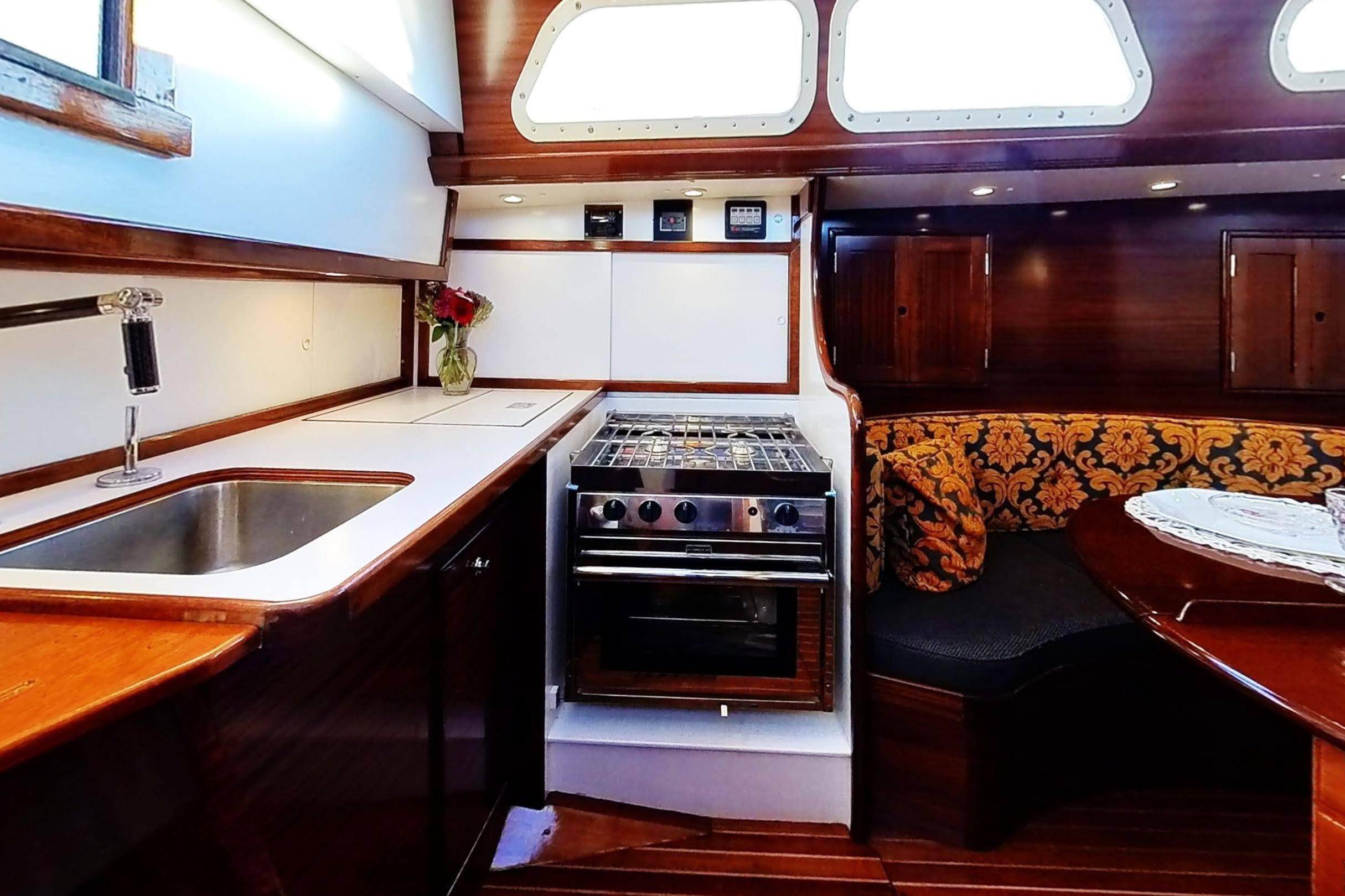 Interior of a 1970 Hinckley Bermuda 40 yacht with kitchen and seating area.