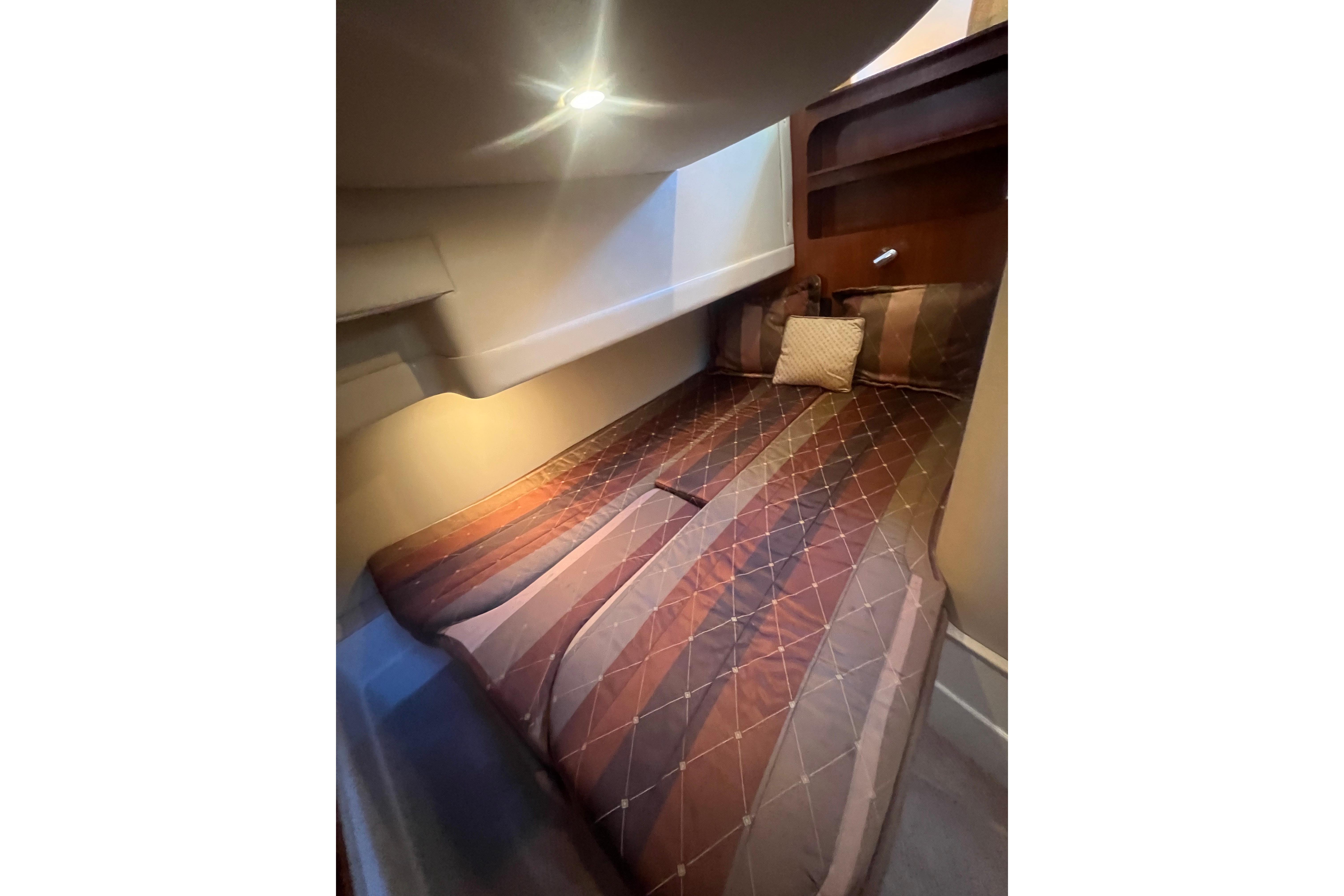 Interior cabin of 2004 Carver 360 Sport Sedan with cozy bed and ambient lighting.