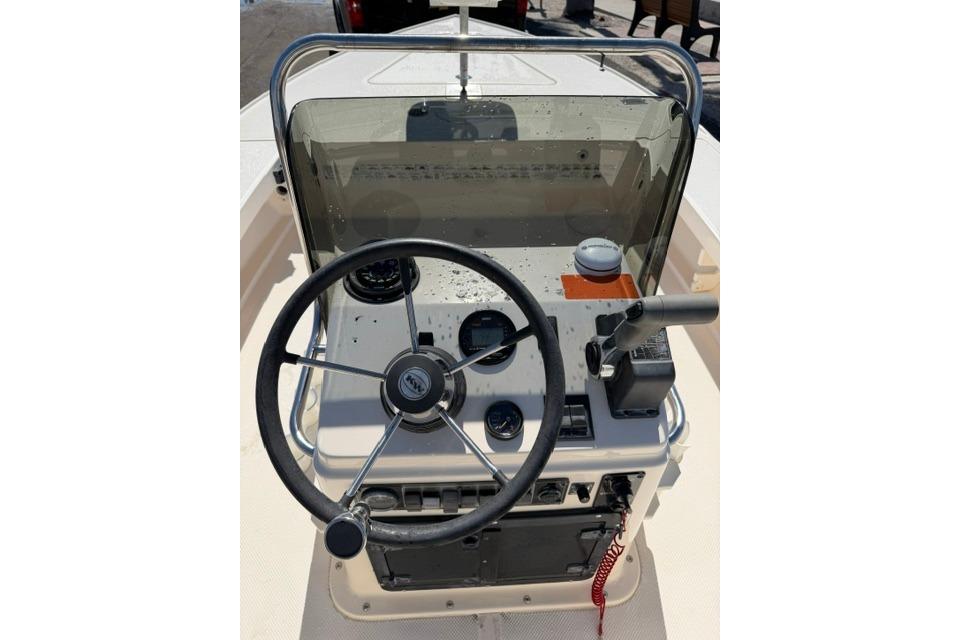 Steering console of a 2002 Key West 1760 Stealth boat with gauges and controls.