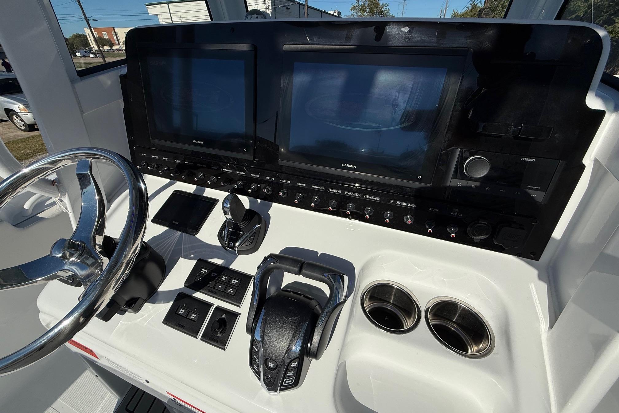 Control panel of 2026 Sea Hunt Ultra 275 Coffin Box boat with steering wheel.