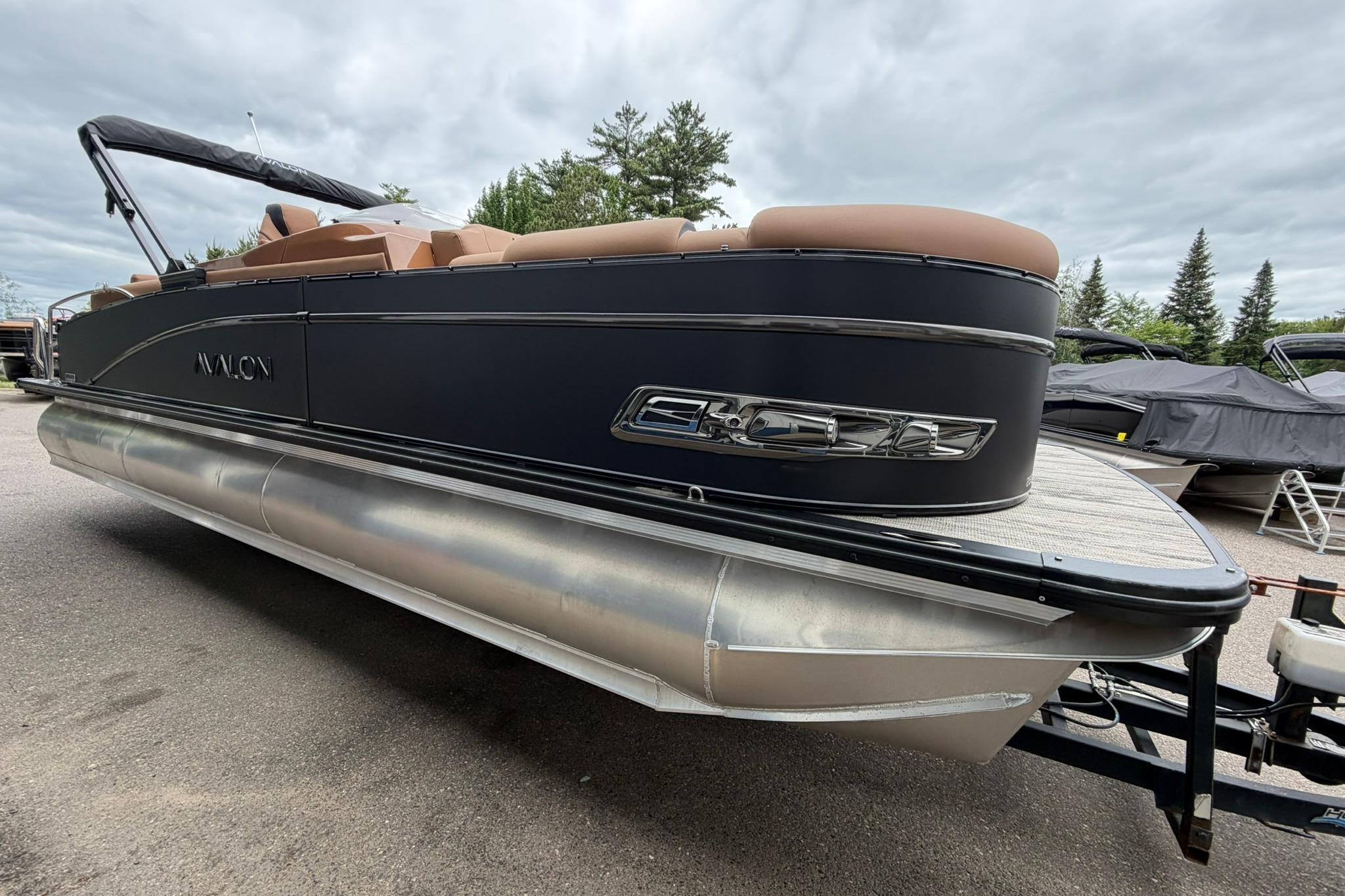 2026 Avalon Catalina Quad Lounge Shift pontoon boat, 25 feet, sleek design, parked outdoors.