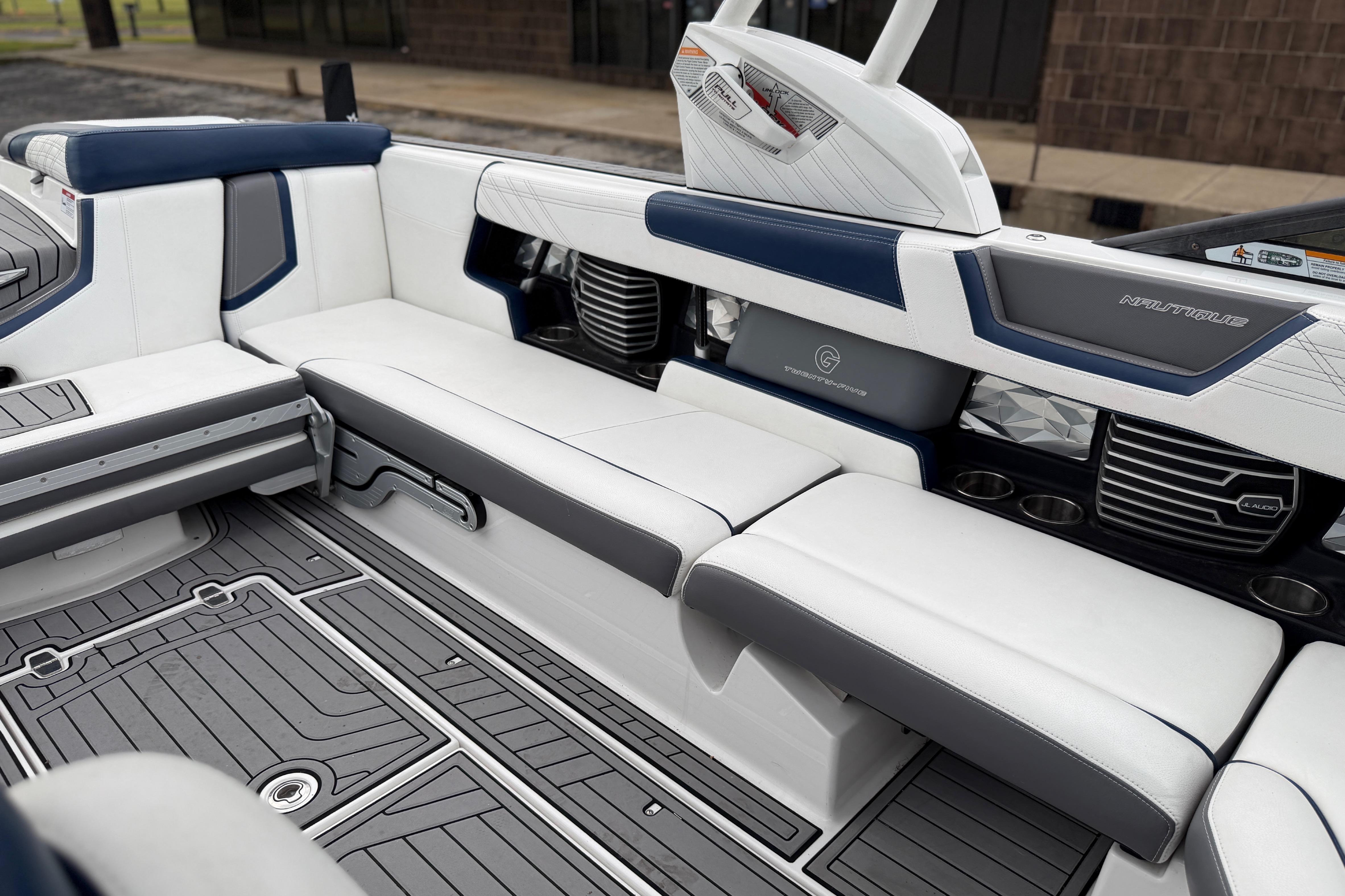 2016 Naitique G25 boat interior with sleek white and blue seating, modern design.