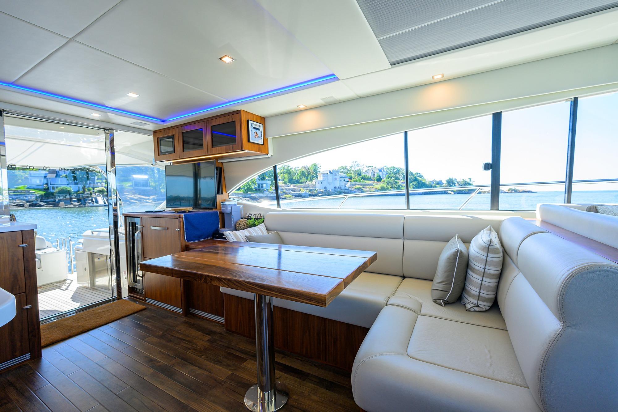 Luxurious interior of 2019 Riviera 5400 Sport Yacht with scenic ocean view.