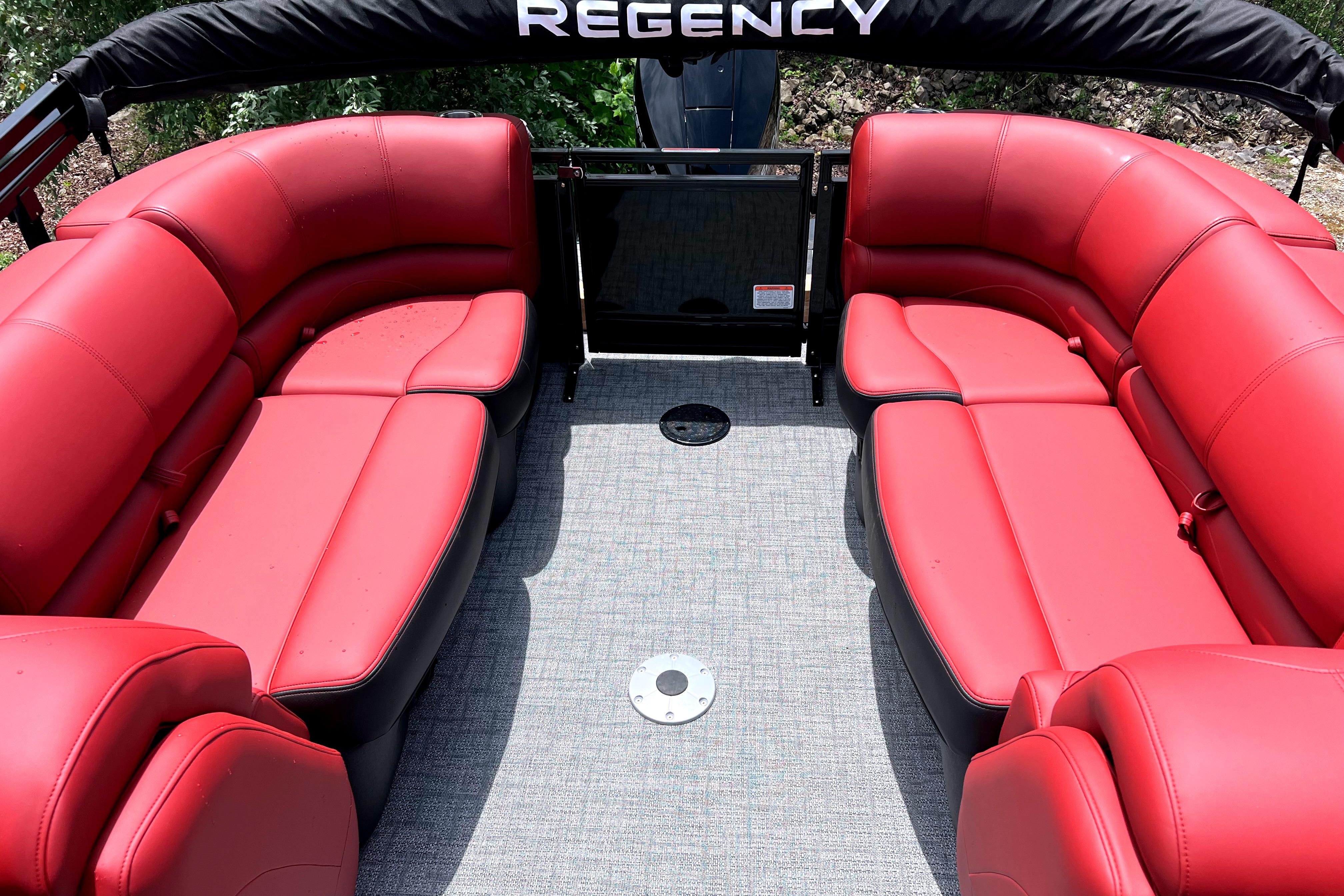 2026 Regency 230 DL boat interior with red seating and gray flooring.