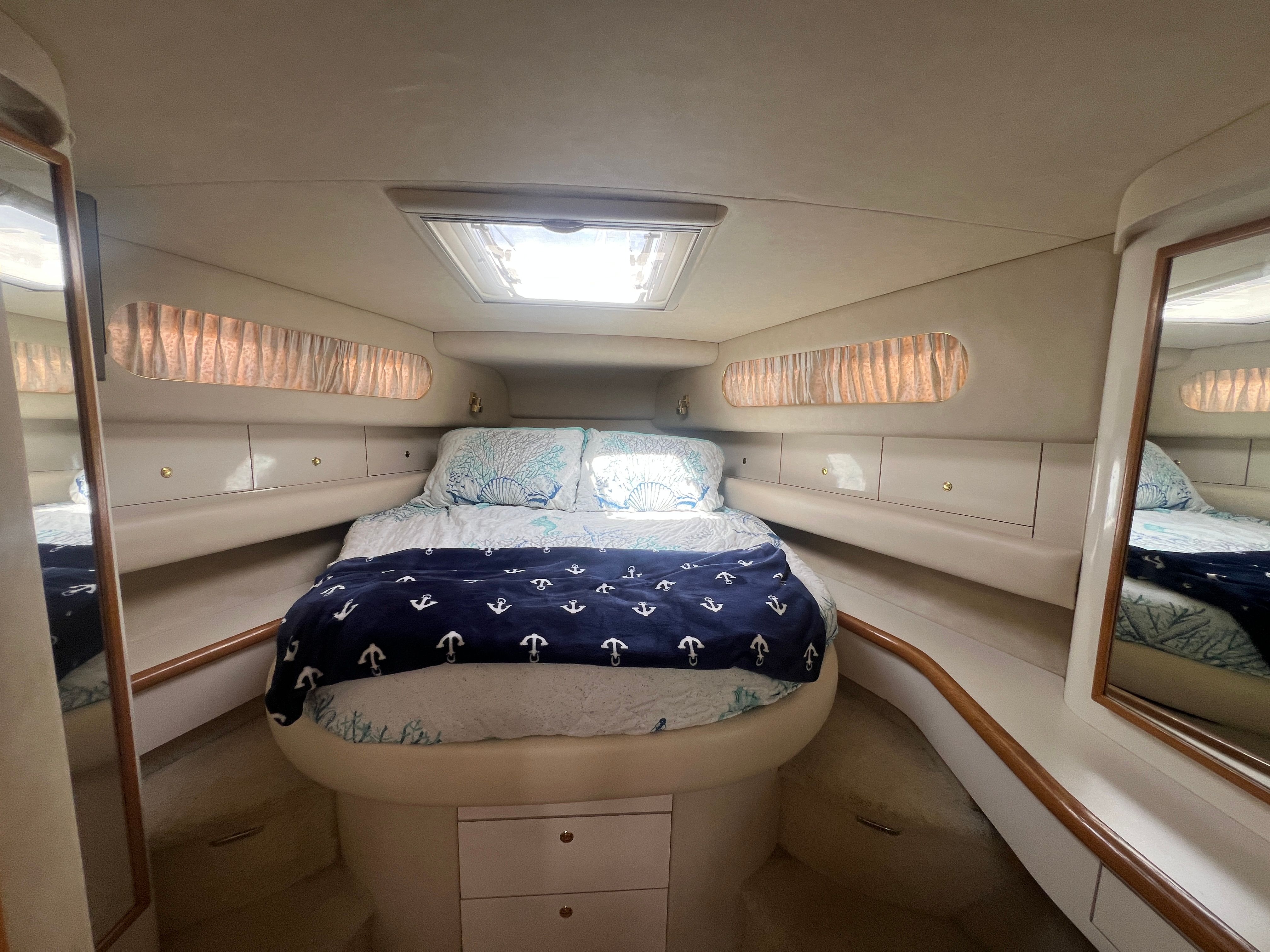 Interior of a 1997 Sea Ray 450 yacht with cozy bed.
