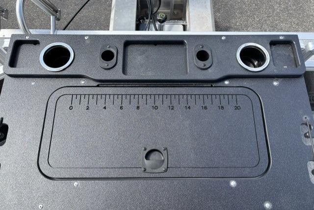 Control panel of 2026 Sun Tracker Fishin' Barge 22 DLX with integrated ruler and cup holders.