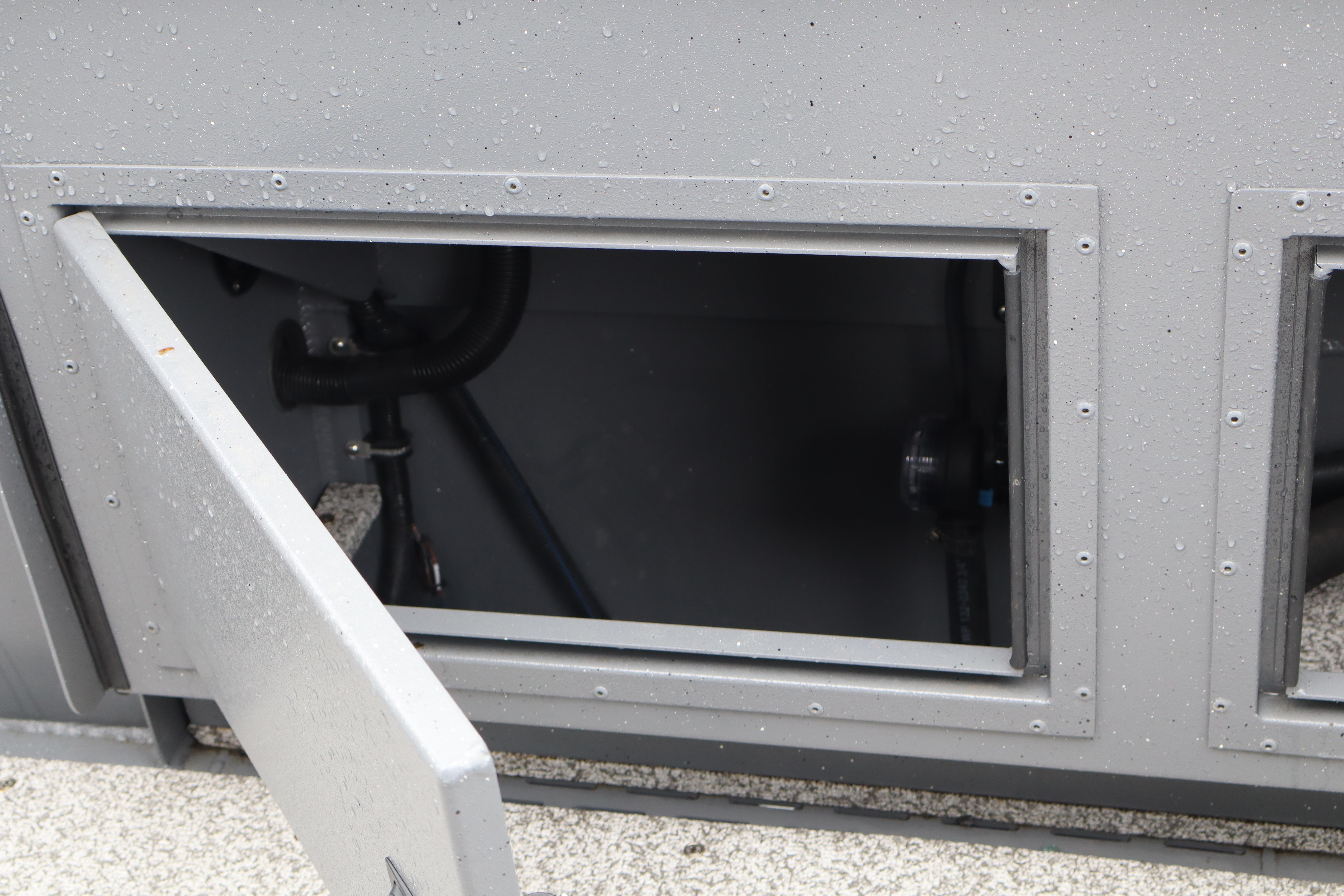 Open compartment on 2026 Alumaweld Horizon 24 boat, showing interior details and components.
