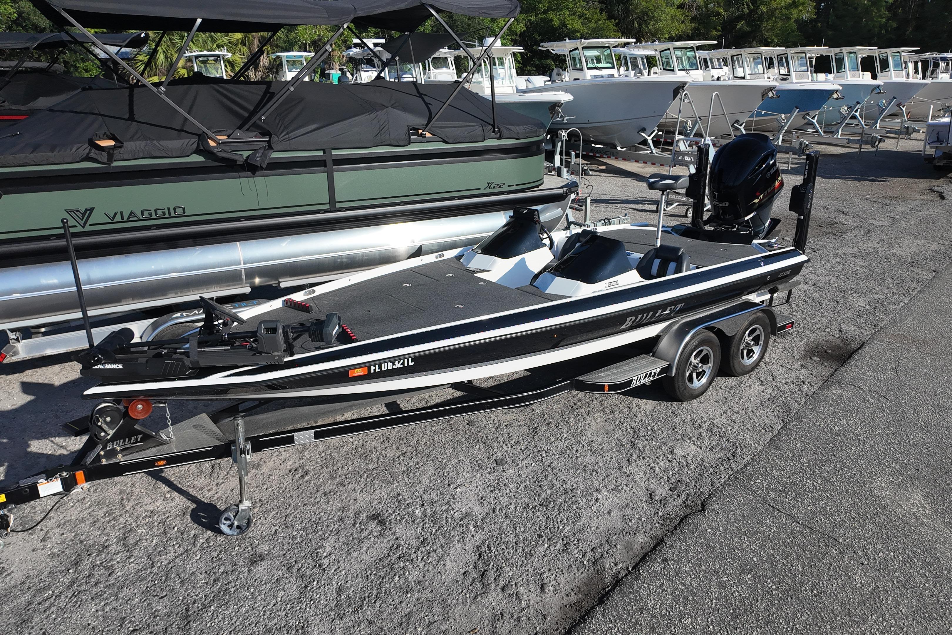 2022 Bullet 21SDC boat on trailer, parked in a marina with other boats.
